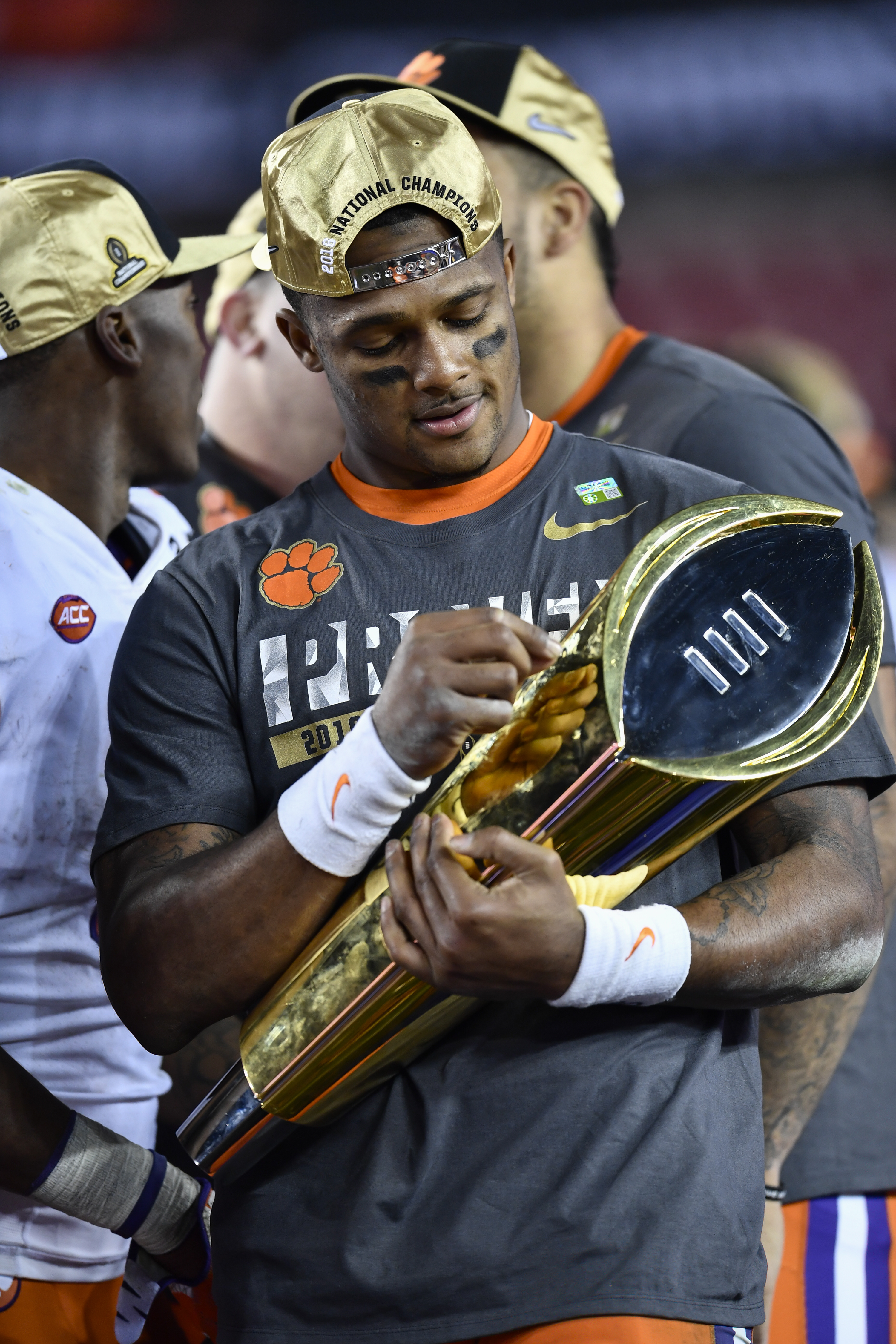 Deshaun Watson holding the National Championship trophy during the award ceremony after the second half of the CFP National Championship game in Tampa, Florida on January 9, 2017. | Source: Getty Images