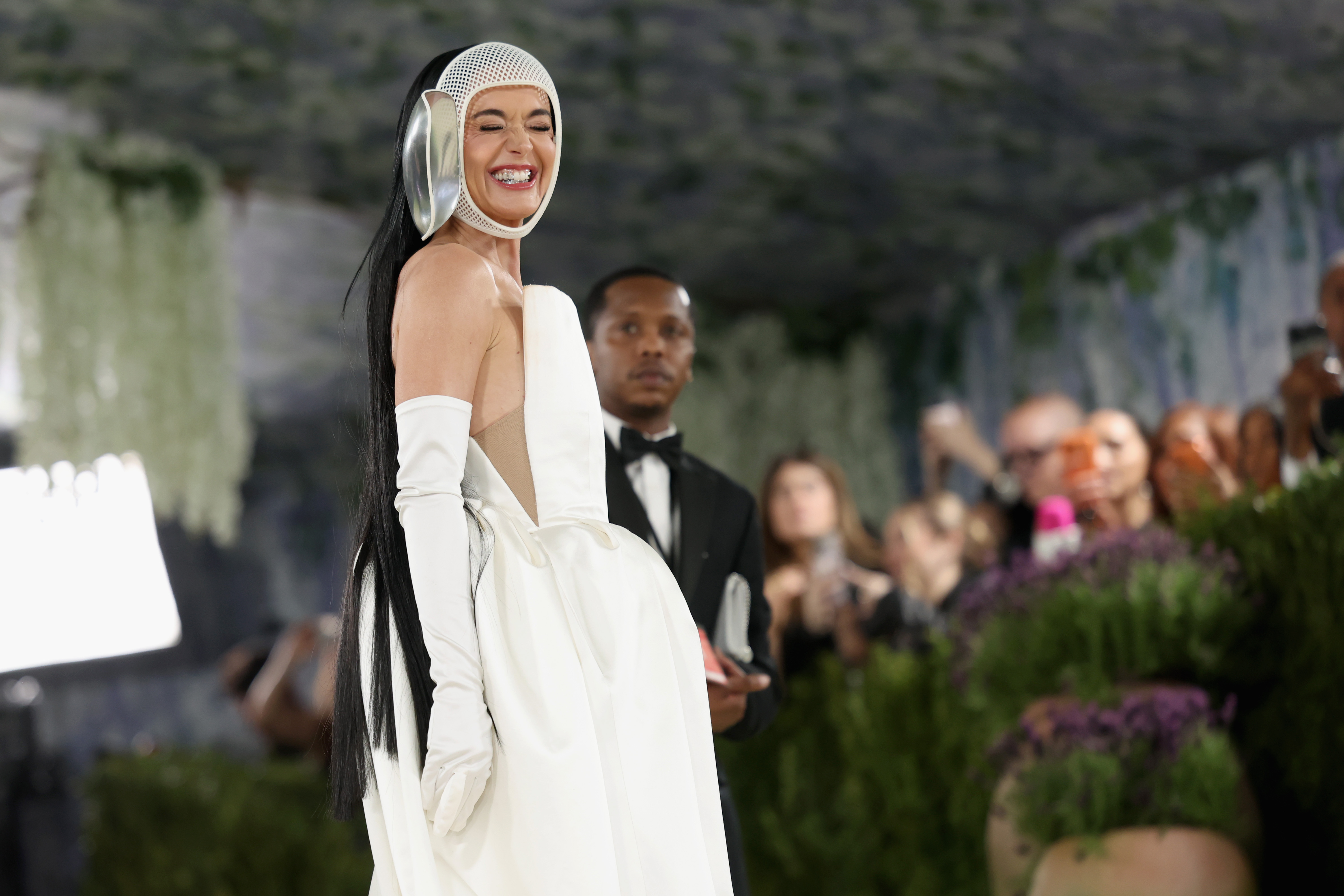 Katy Perry smiles while posing in a bold, avant-garde ensemble | Source: Getty Images
