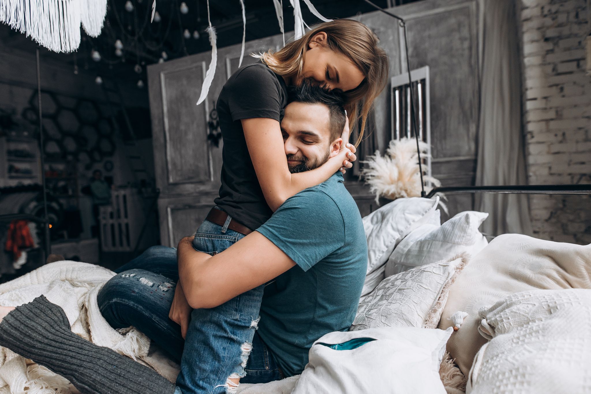 A couple hugging in bed | Source: Shutterstock