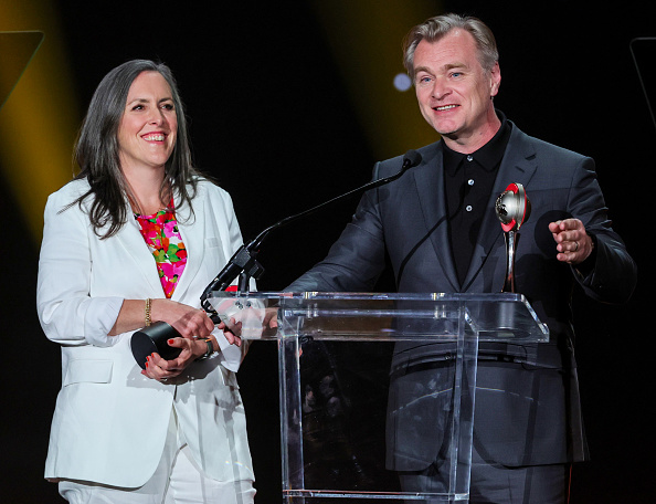 Christopher Nolan and Emma Thomas on the stage at the National Association of Theatre Owners Spirit of the Industry Awards on April 27, 2023, in Las Vegas. │ Source: Getty Images