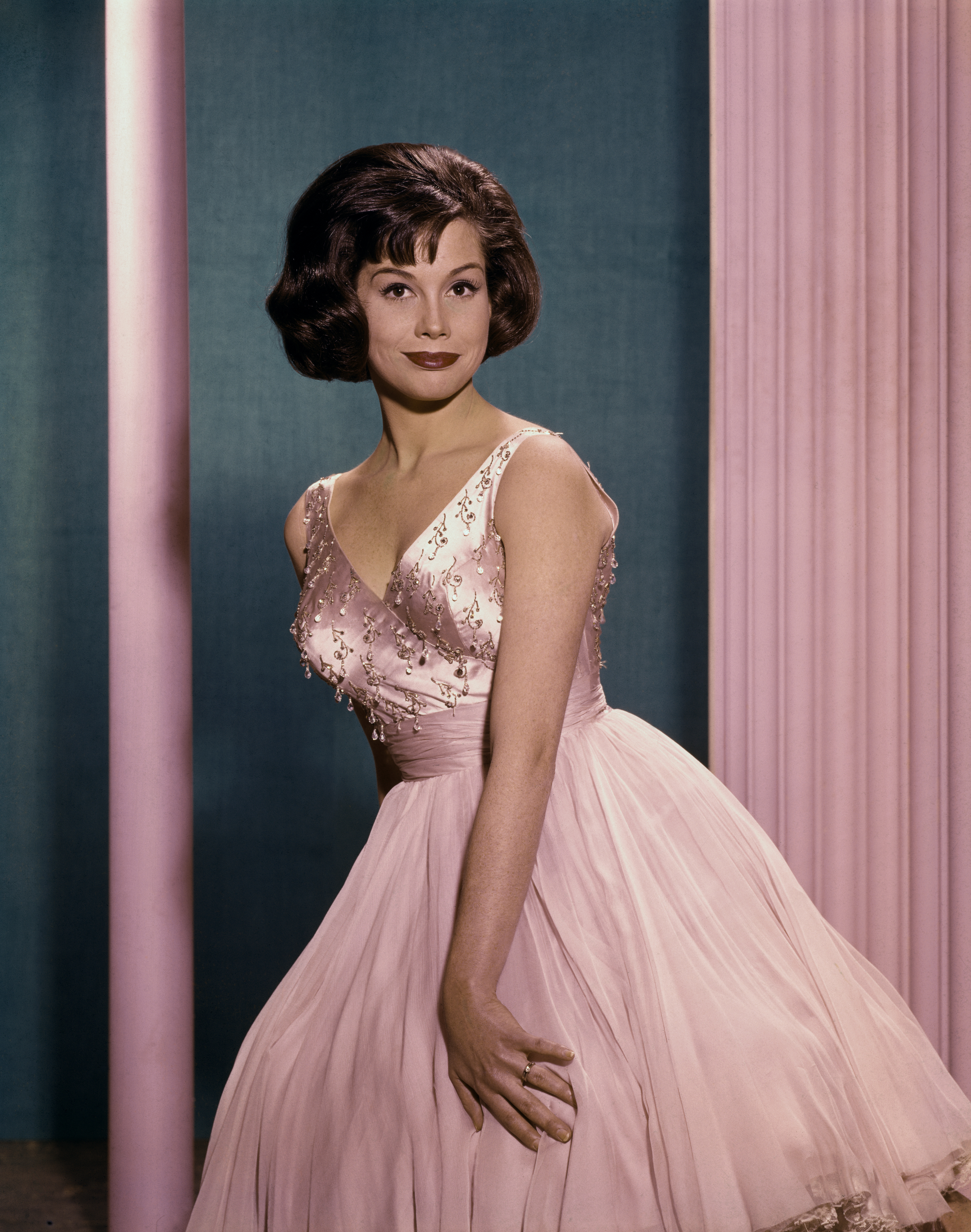 Mary Tyler Moore is pictured wearing a pink evening dress in a full-length publicity still, circa 1965. | Source: Getty Images