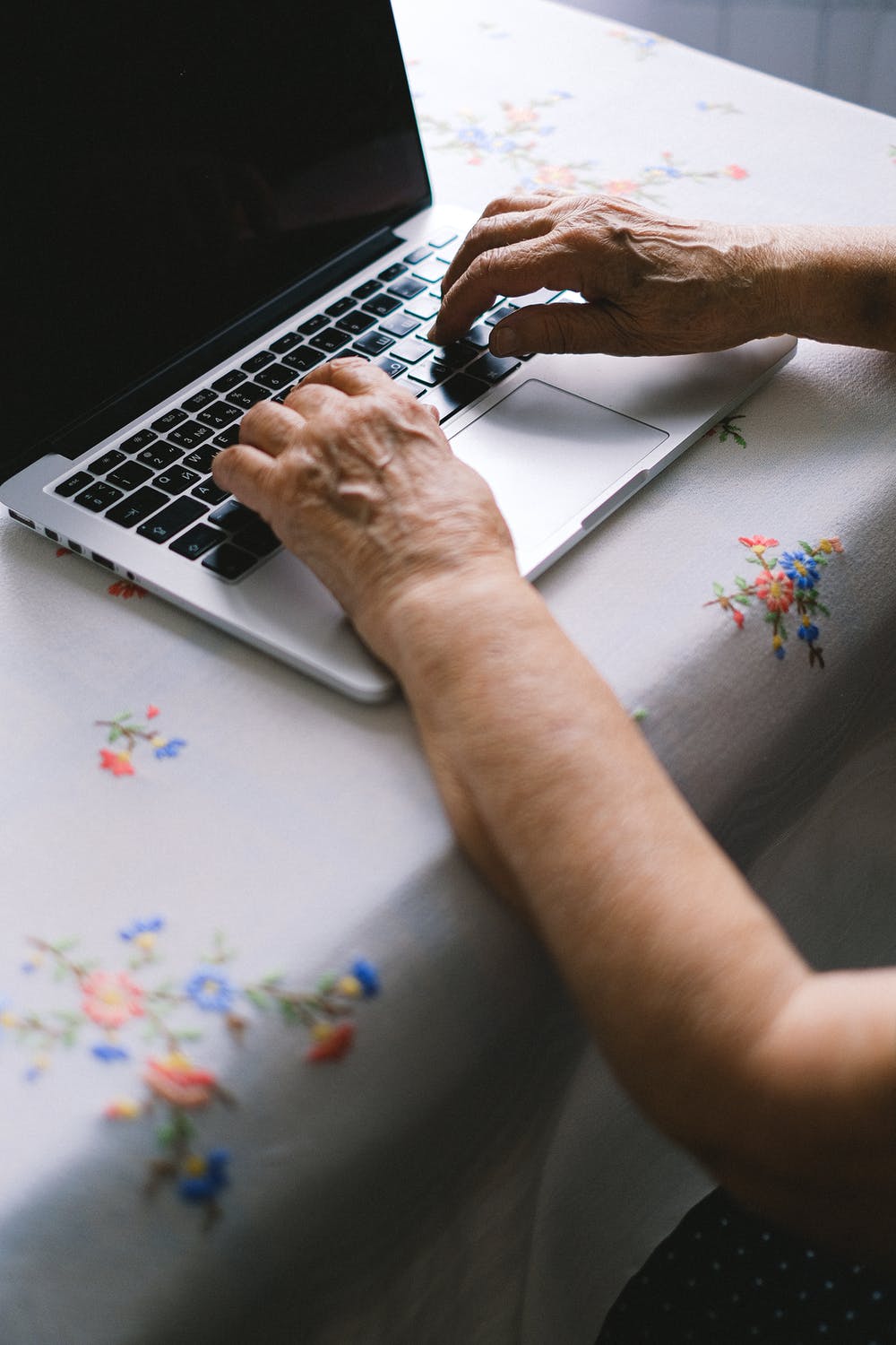 Hands typing on a computer. | Source: Pexels