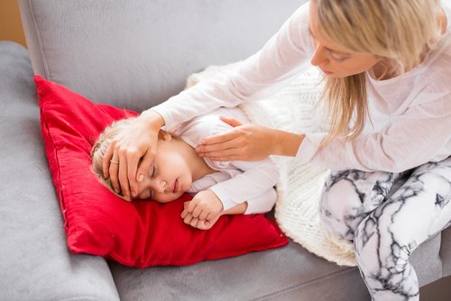 Mother with her sick child at home. | Source: Shutterstock