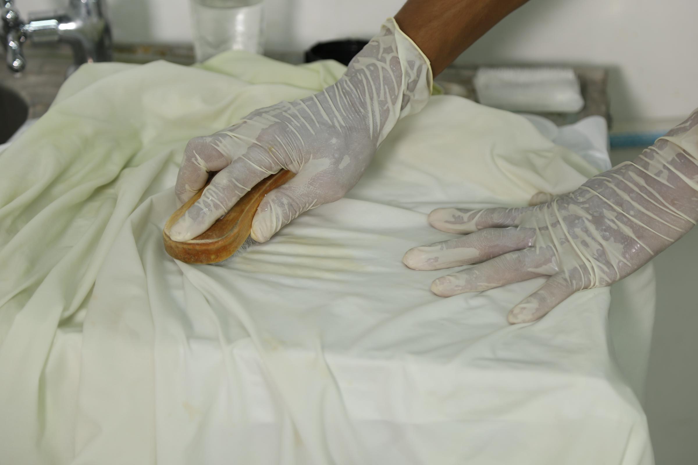 A person cleaning dirtied fabric | Source: Pexels