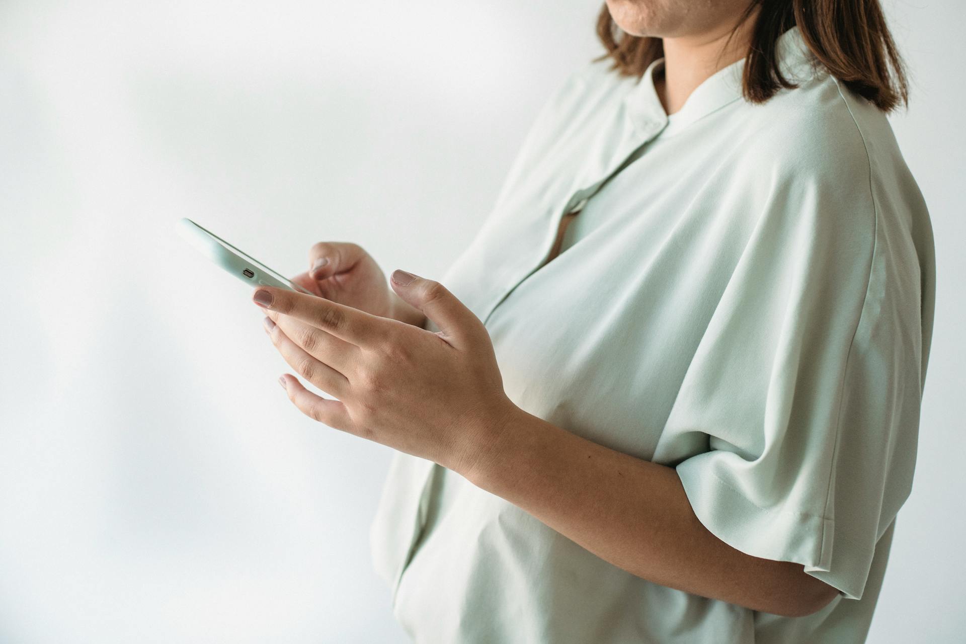 A woman using her phone | Source: Midjourney