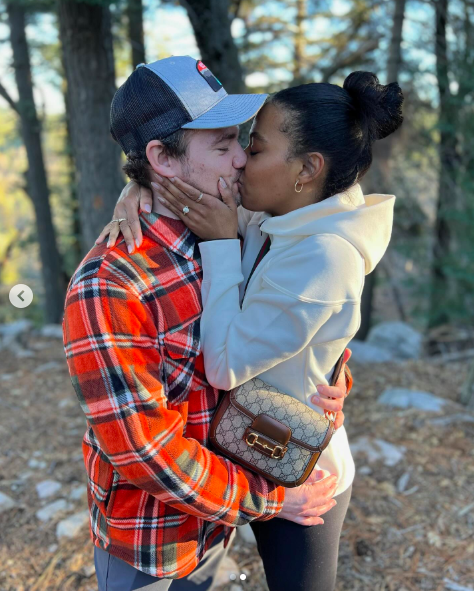 Daniel Durant and Britt Stewart sharing a kiss after they got engaged, posted on December 29, 2023. | Source: Instagram/brittbenae and danielndurant