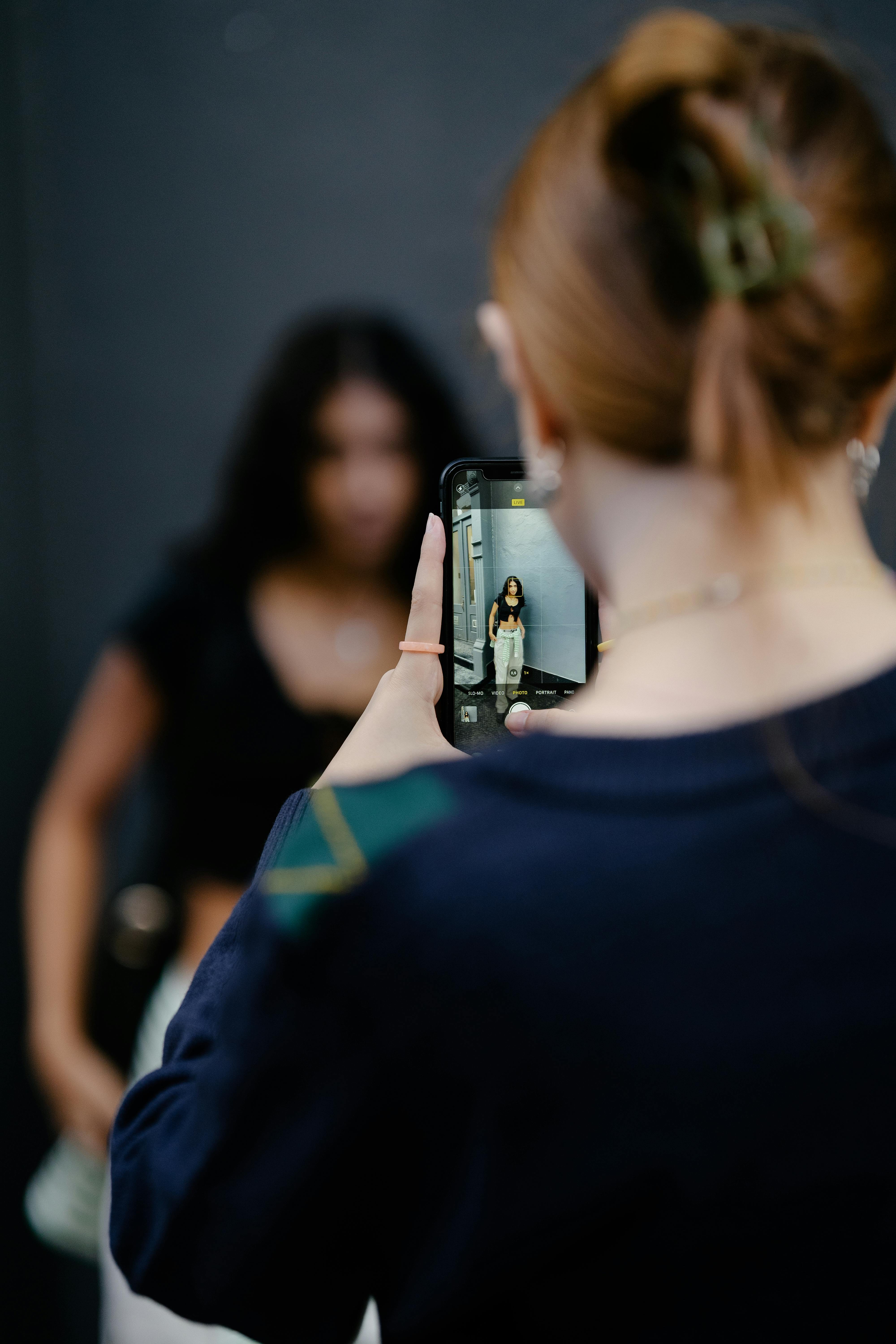 A woman taking a photo of another woman | Source: Pexels