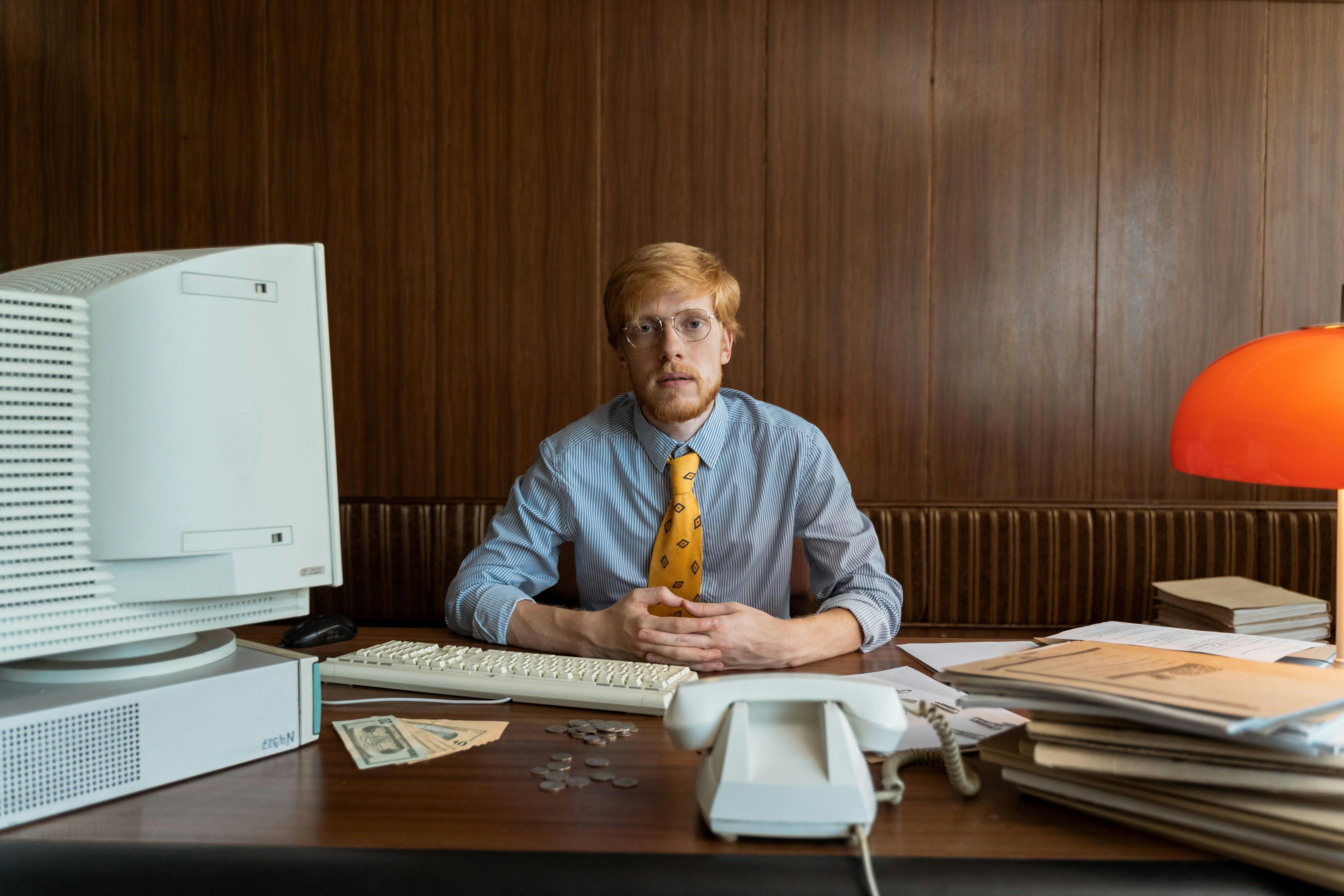 A man sitting at his office desk | Source: Pexels