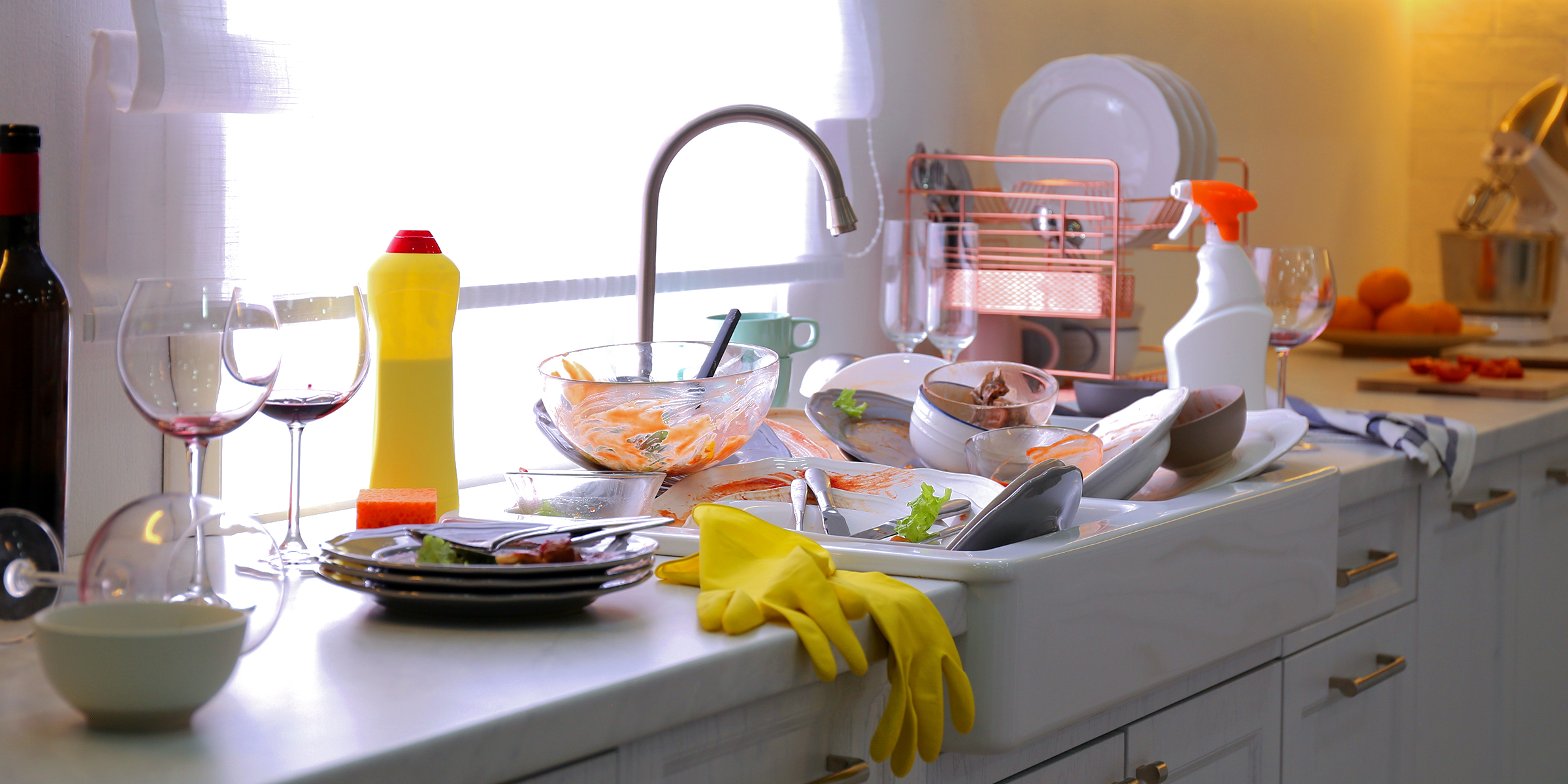 Dirty dishes piled up on a kitchen counter | Source: Shutterstock