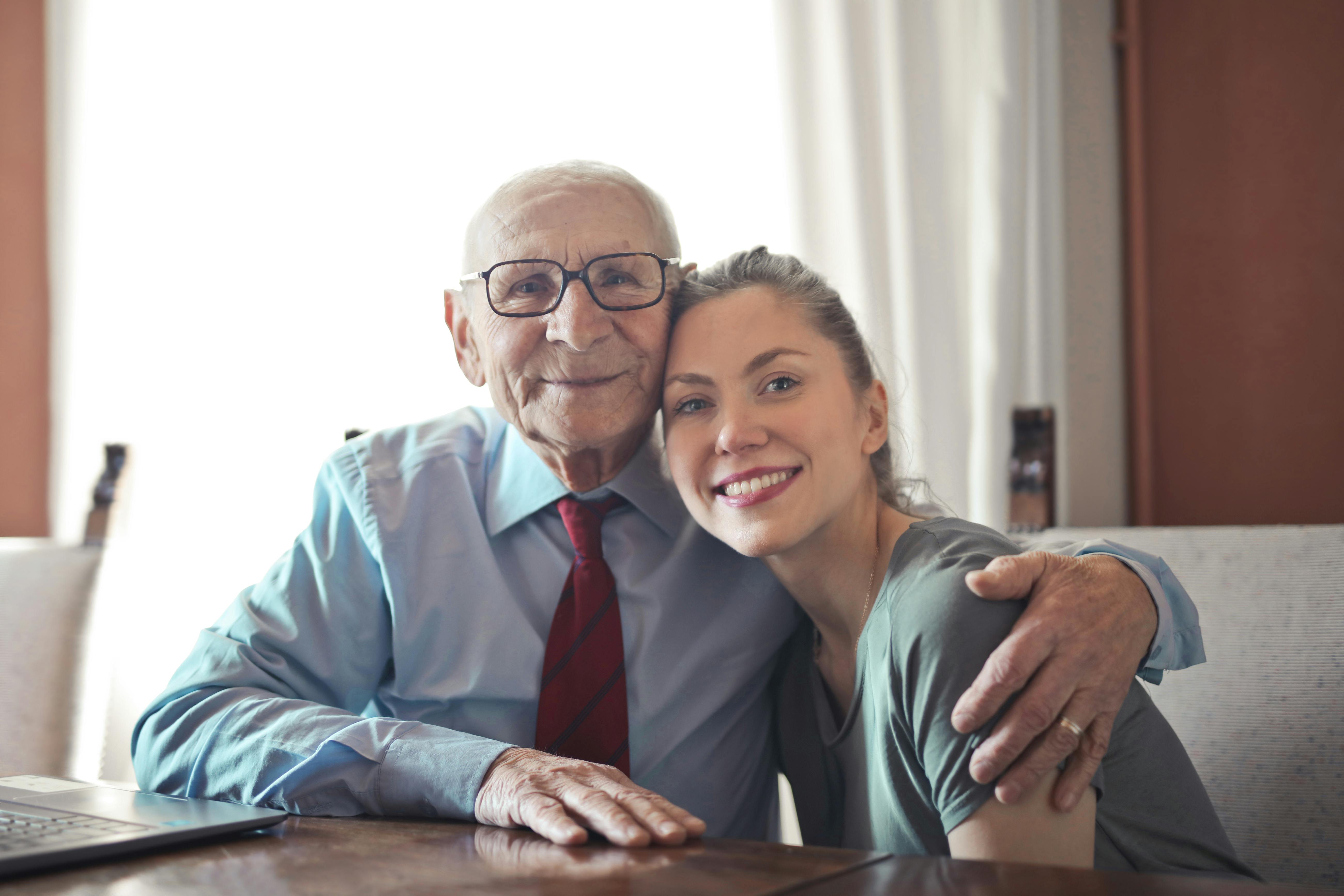 A happy woman with her grandfather | Source: Pexels