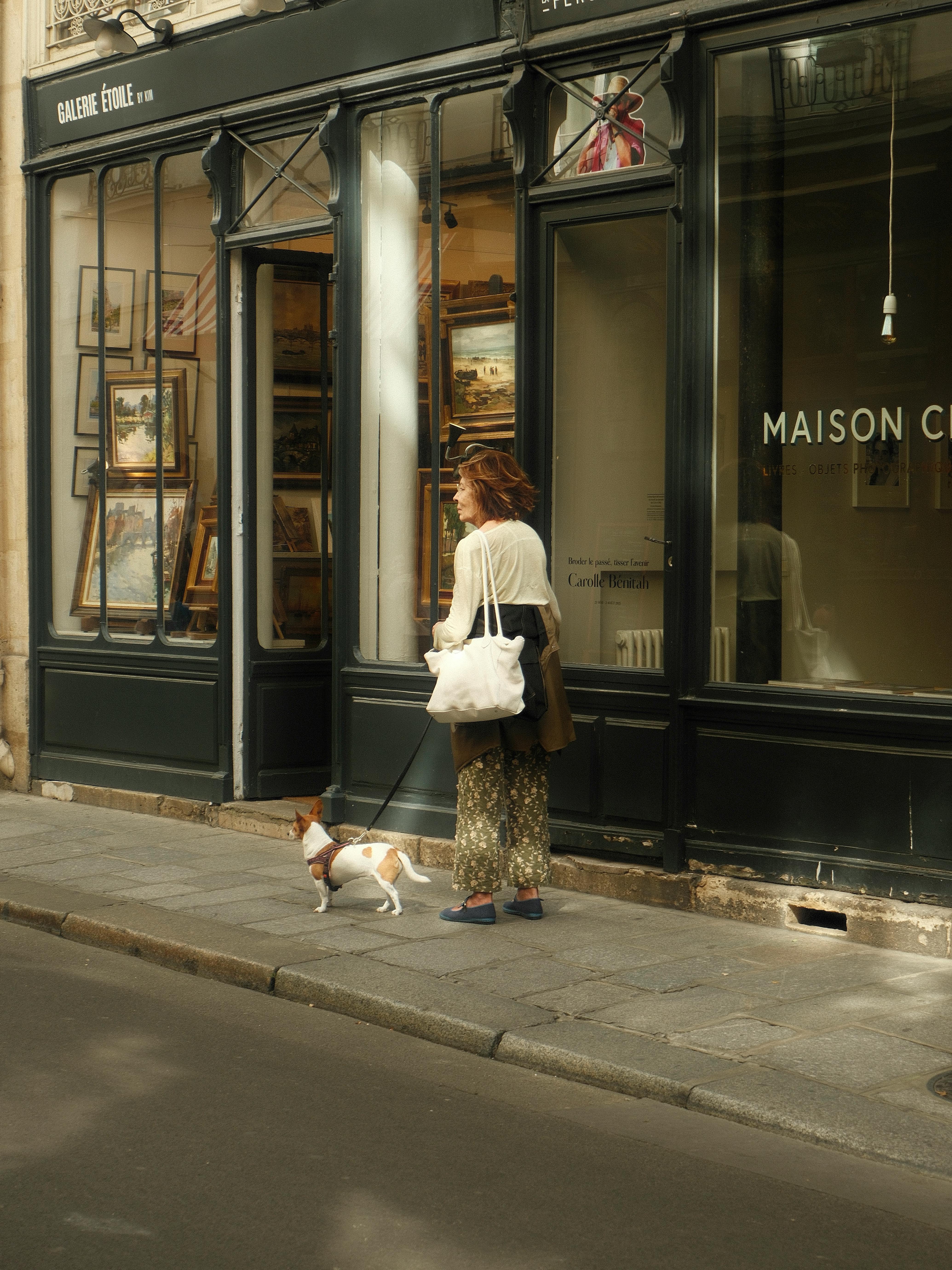 A woman taking her dog out for a walk | Source: Pexels