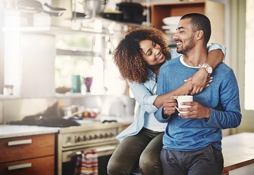 A happy couple relaxing in their home | Photo: Getty Images