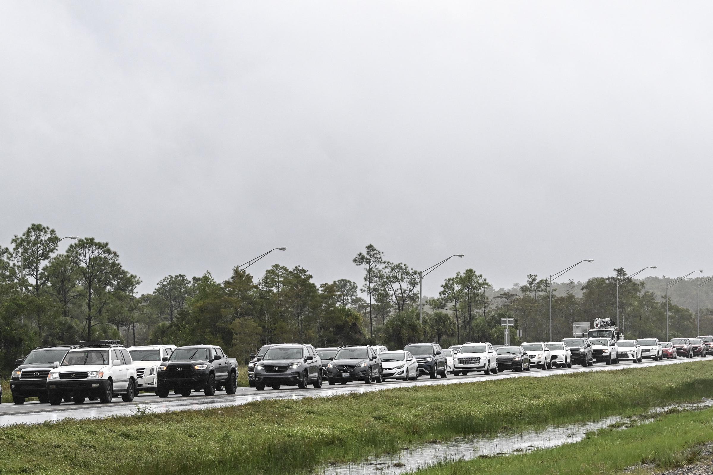 Cars pictured lined up on the road during evacuation as Hurricane Milton approaches on October 8, 2024, in Naples, Florida. | Source: Getty Images