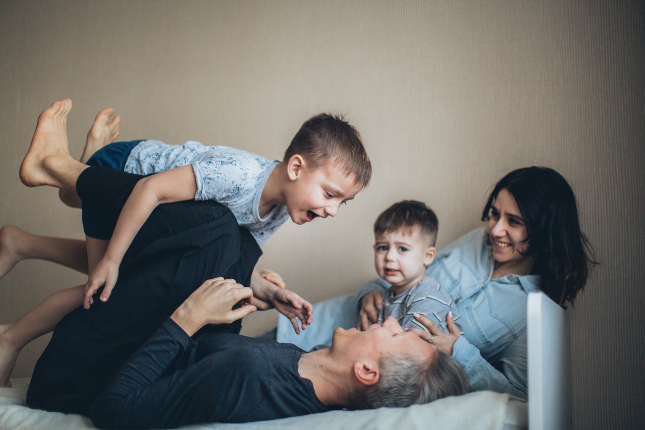 Couple playing with two children. / Source: Pexels/Elly Fairytale