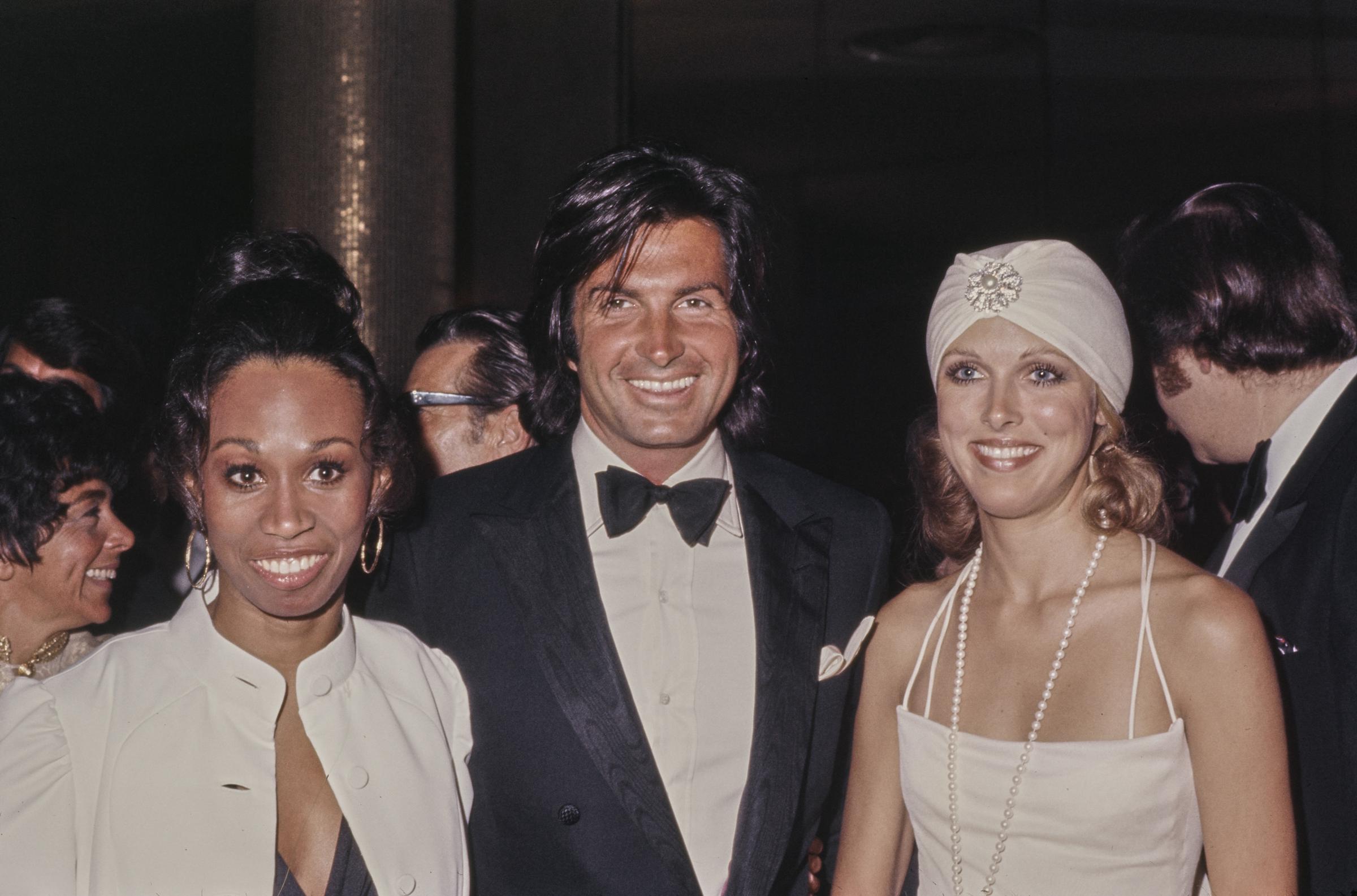 American dancer Altovise Davis, American actor George Hamilton, and his wife, American actress Alana Hamilton, attend an event in the United States, circa 1973. | Source: Getty Images