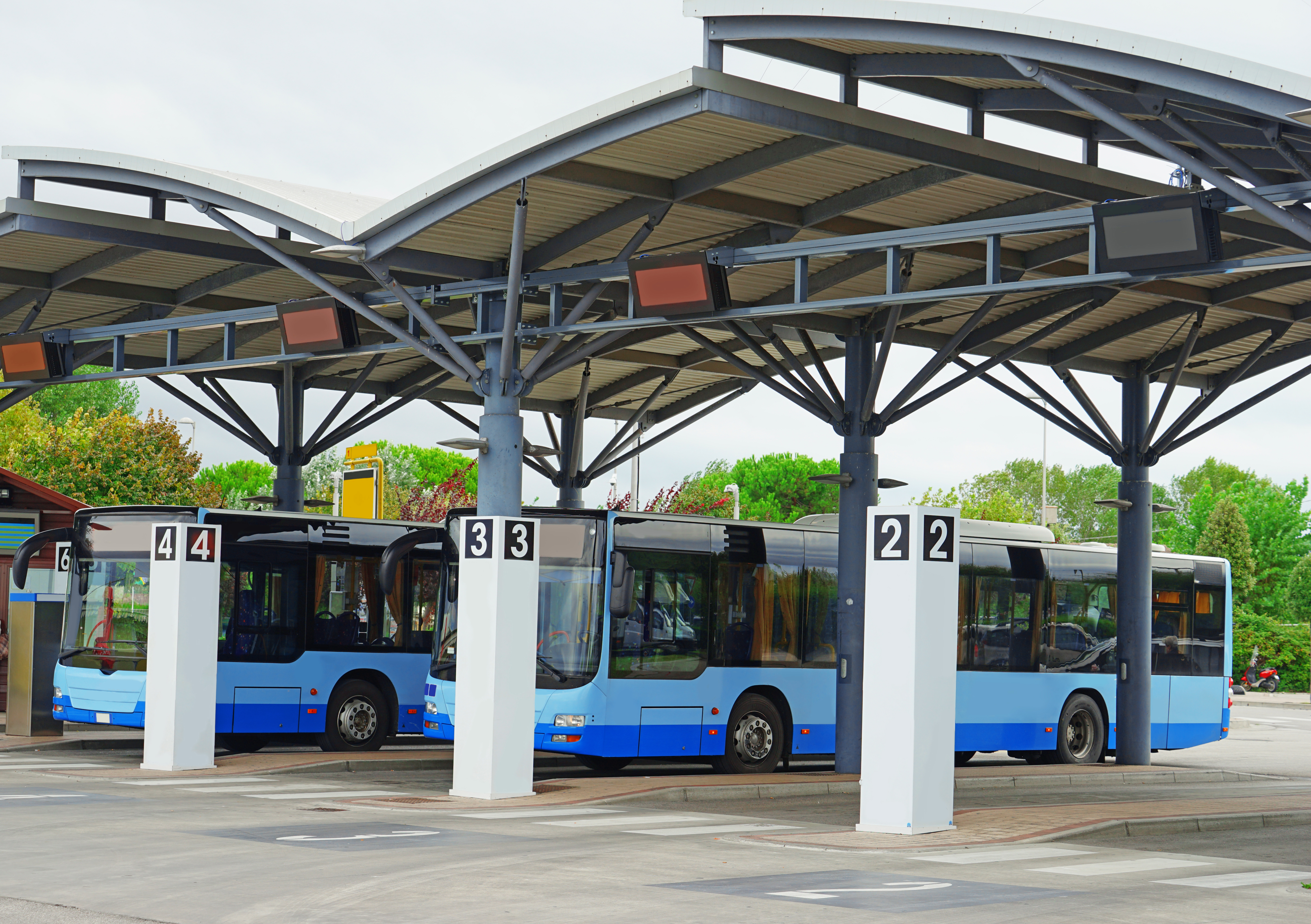 Bus station with blue buses. | Source: Shutterstock