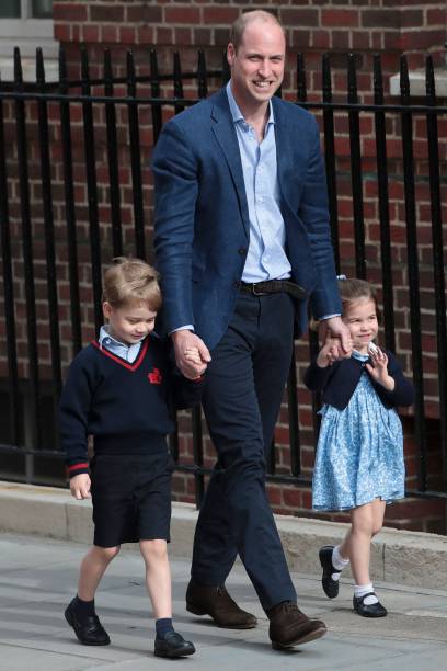 Princess Charlotte and her brother Prince George led by their father, Prince William, at the Lindo Wing of St Mary's Hospital in central London, on April 23, 2018 | Photo: Getty Images