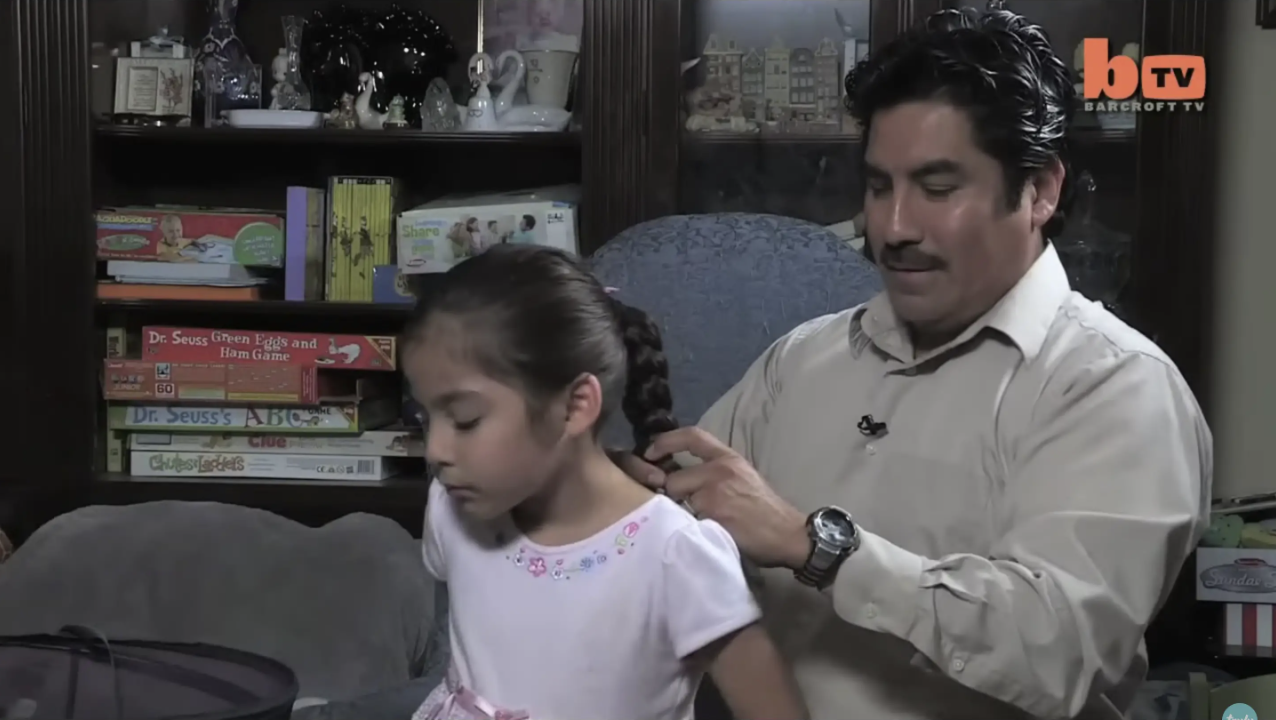 Frank Garcia with his daughter during an interview. | Source: YouTube/Truly