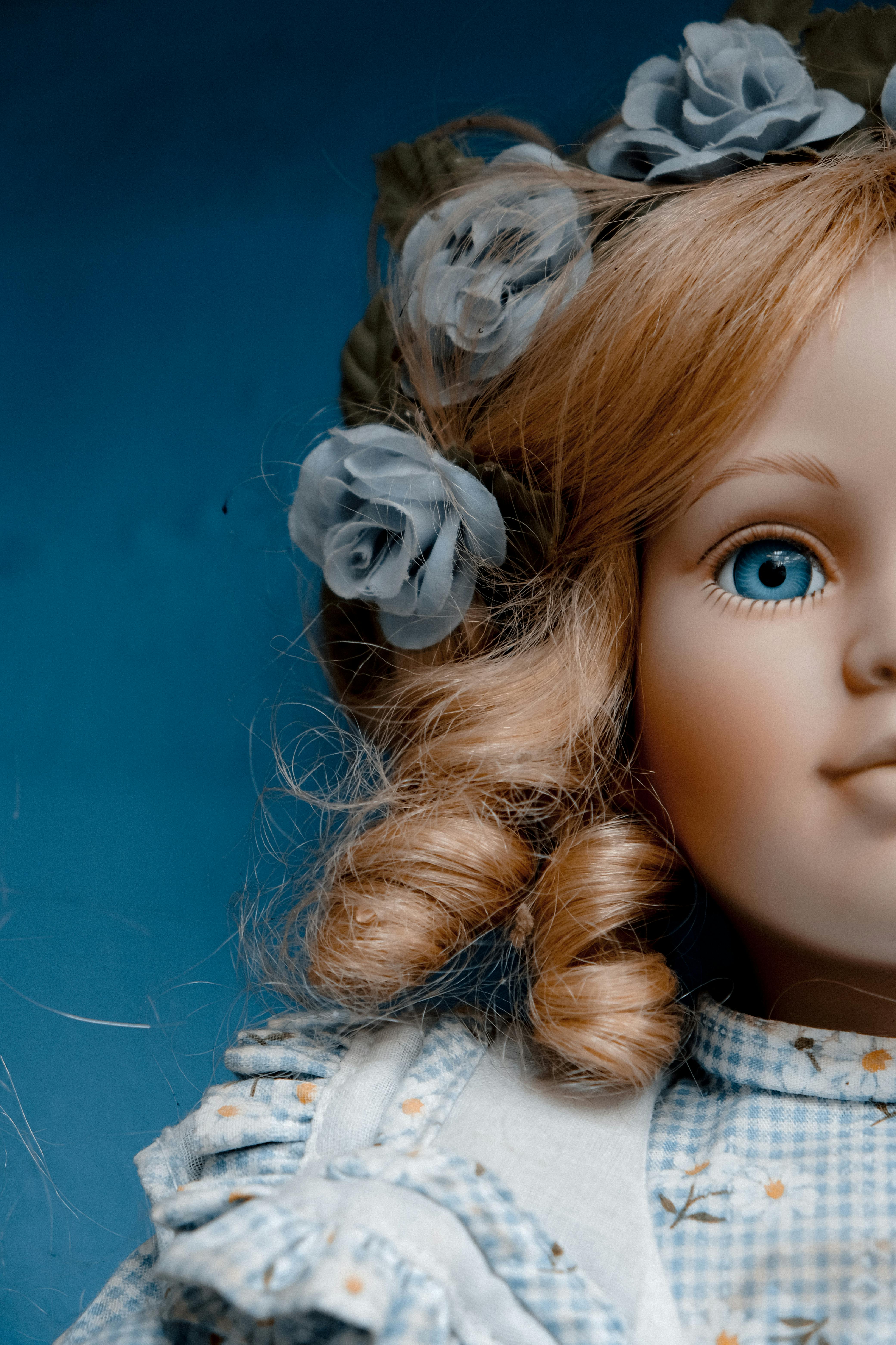 A porcelain doll wearing a blue dress | Source: Pexels