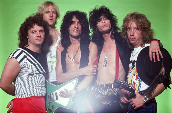 Brad Whitford, Joe Perry, Joey Kramer, Tom Hamilton, and Steven Tyler of Aerosmith pose for a portrait on July 11, 1984 at Pine Knob Music Center in Clarkston, Michigan. | Photo: Getty Images