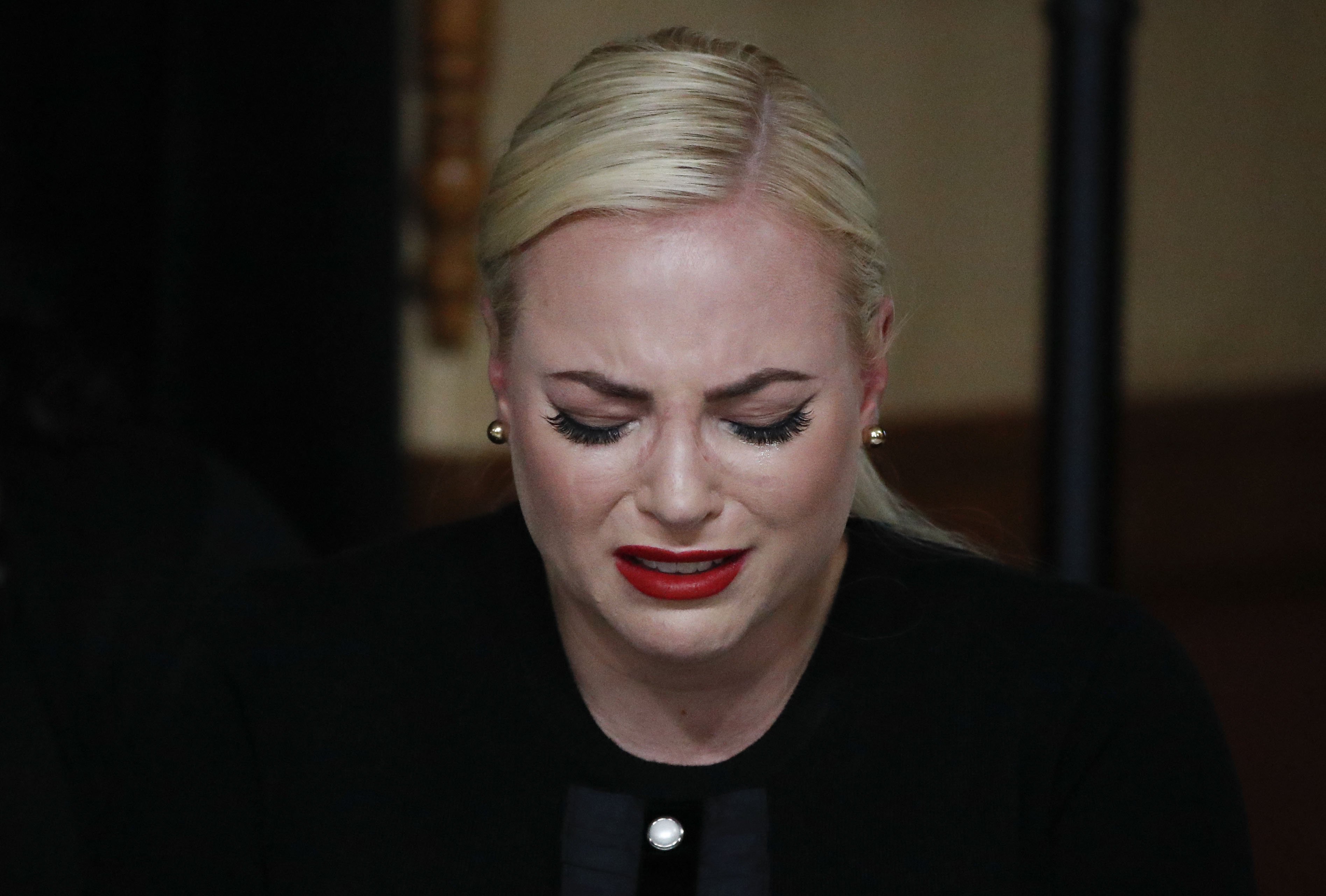  Meghan McCain, touches the casket during a memorial service for the late Sen. John McCain, at the Arizona Capitol on August 29, 2018, in Phoenix, Arizona | Source : Getty Images 