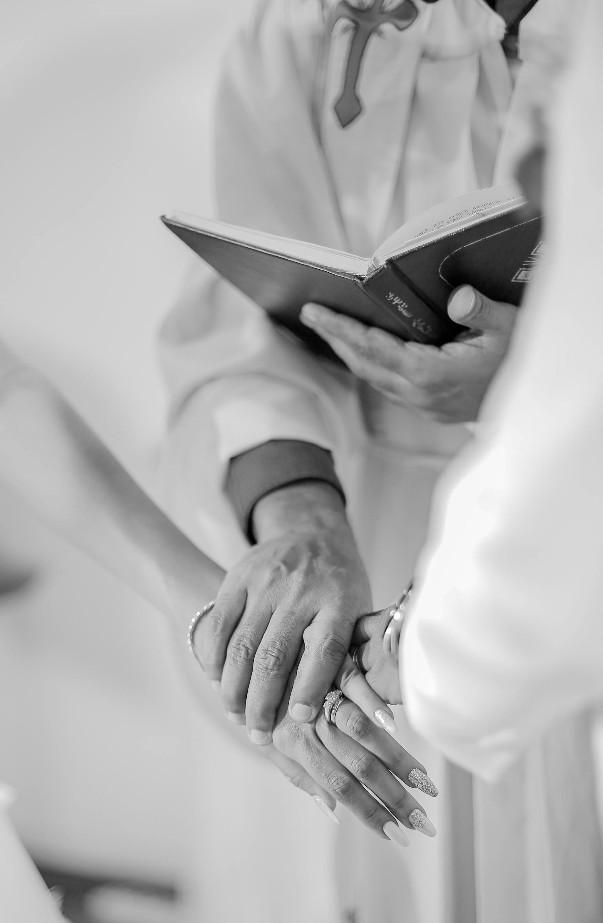 A priest holding the bride and groom | Source: Pexels