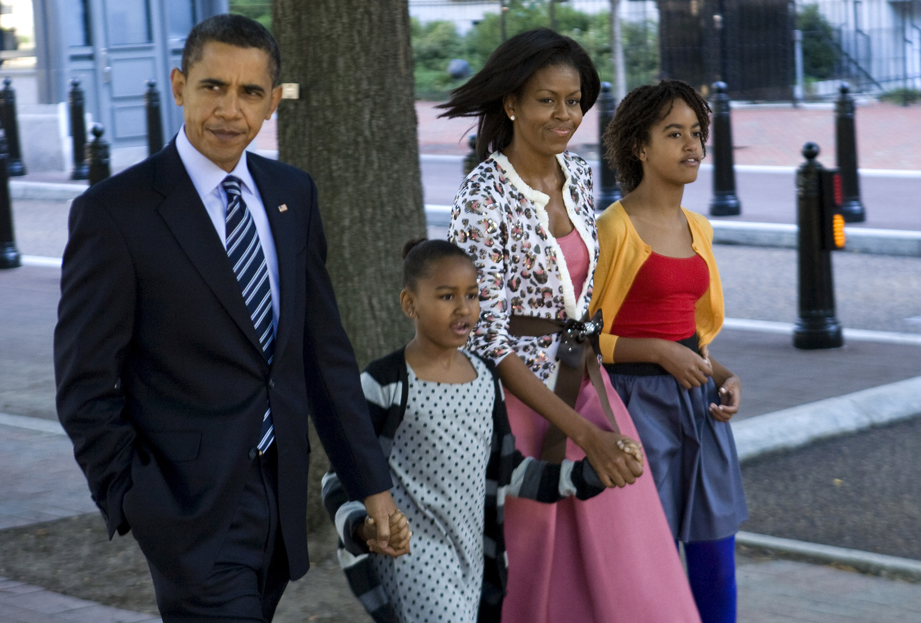 Barack, Sasha, Michelle, and Malia Obama walking across Pennsylvania Avenue as they return from a morning service at St. John's Episcopal Church in Washington, D.C. on October 11, 2009. | Source: Getty Images