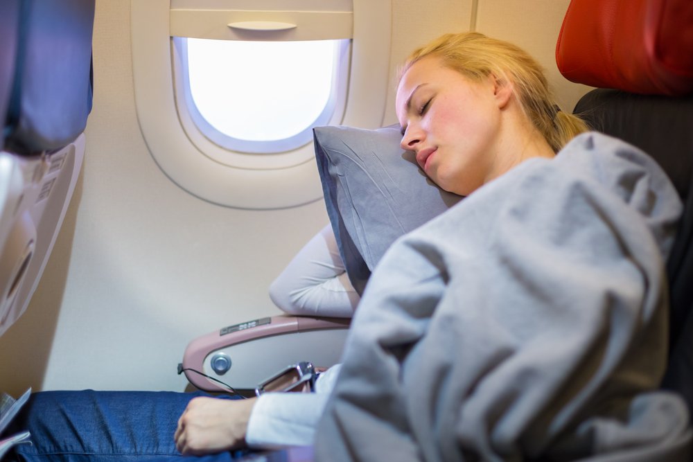 Blonde woman sleeping on a plane. | Source: Shutterstock