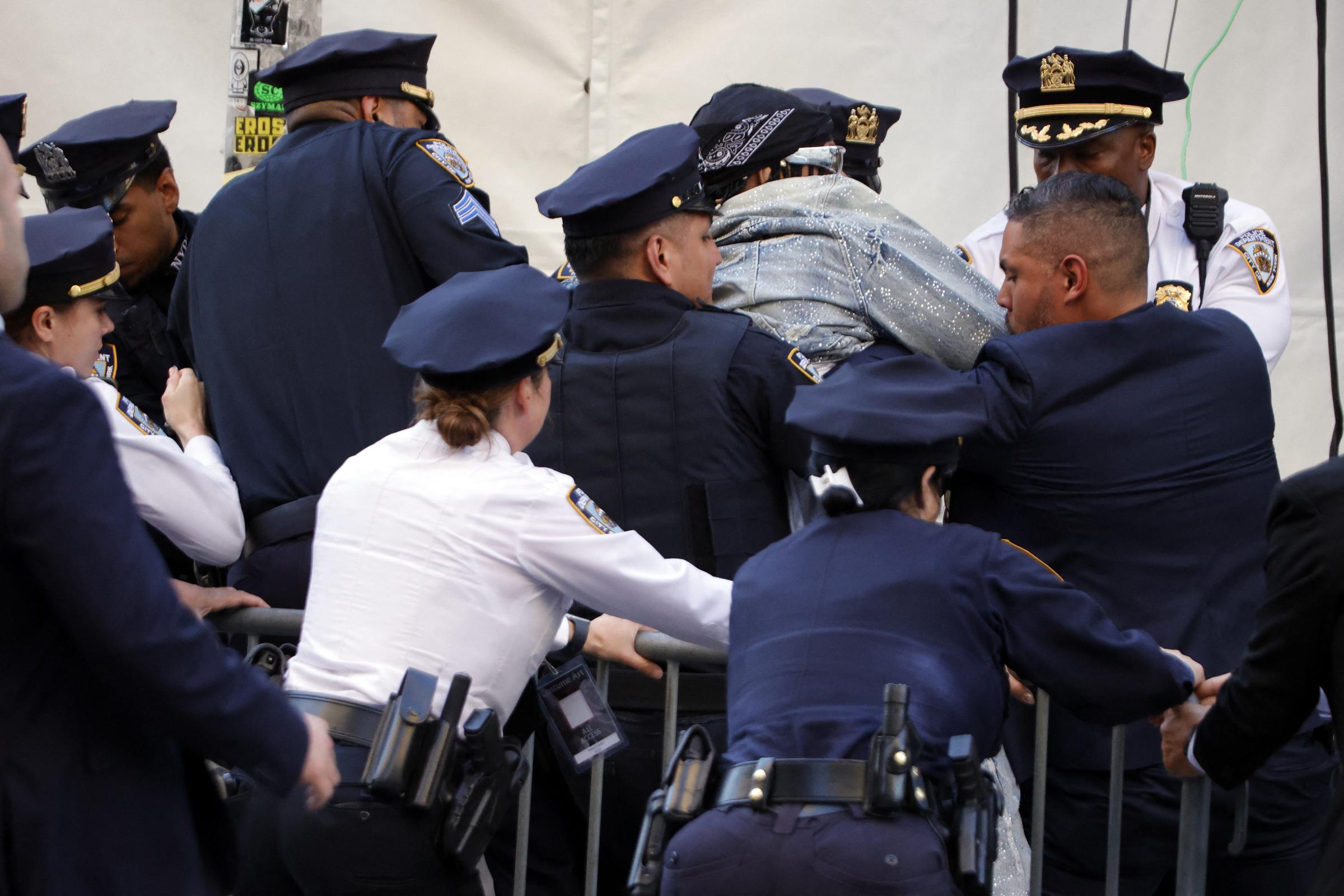 NYPD officers detain a man after he tried to break into the red carpet of the 2026 Met Gala | Source: Getty Images