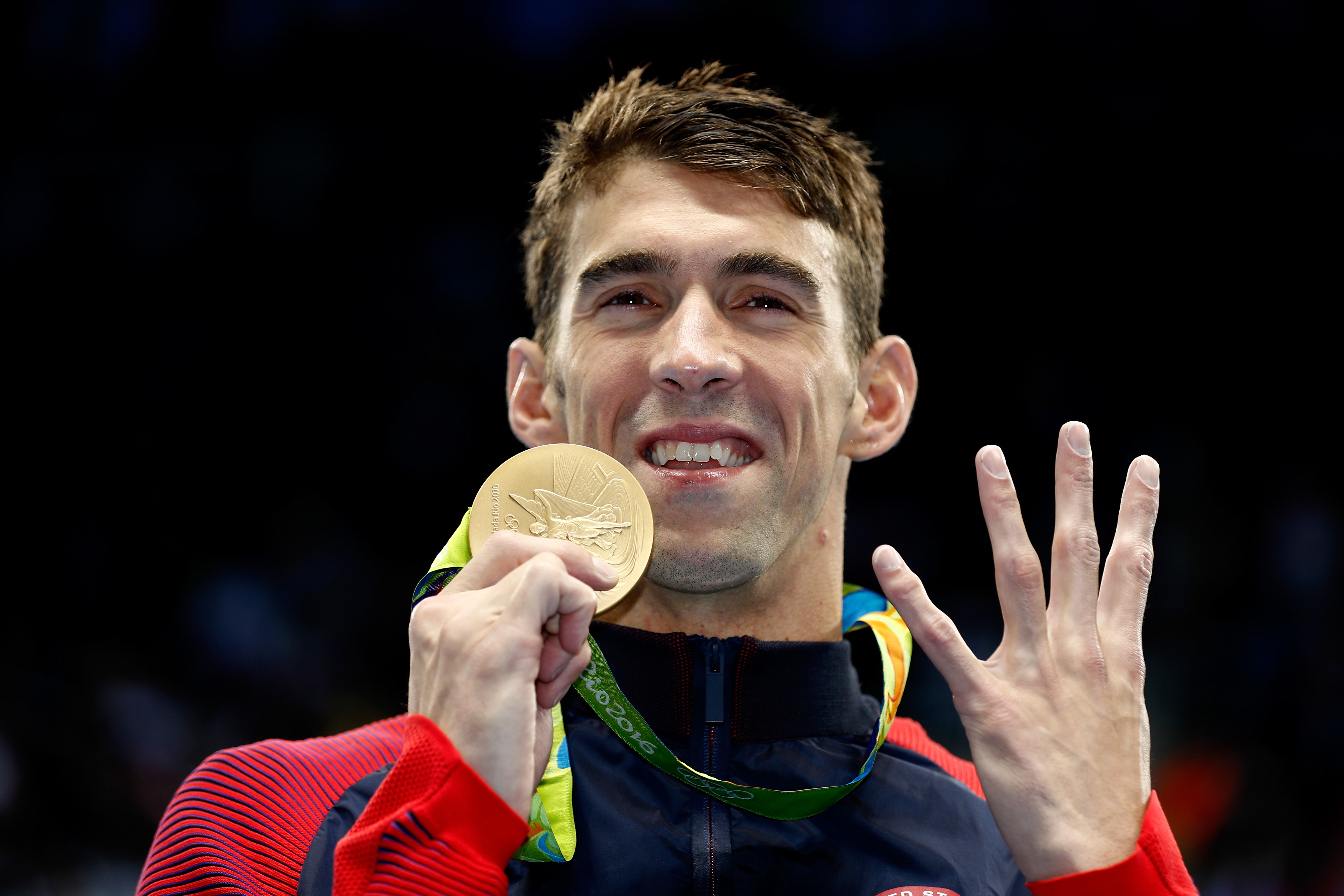 Michael Phelps joyously celebrates during the medal ceremony for the Men's 200m Individual Medley Final on Day 6 of the Rio 2016 Olympic Games at the Olympic Aquatics Stadium in Rio de Janeiro, Brazil | Source: Getty Images