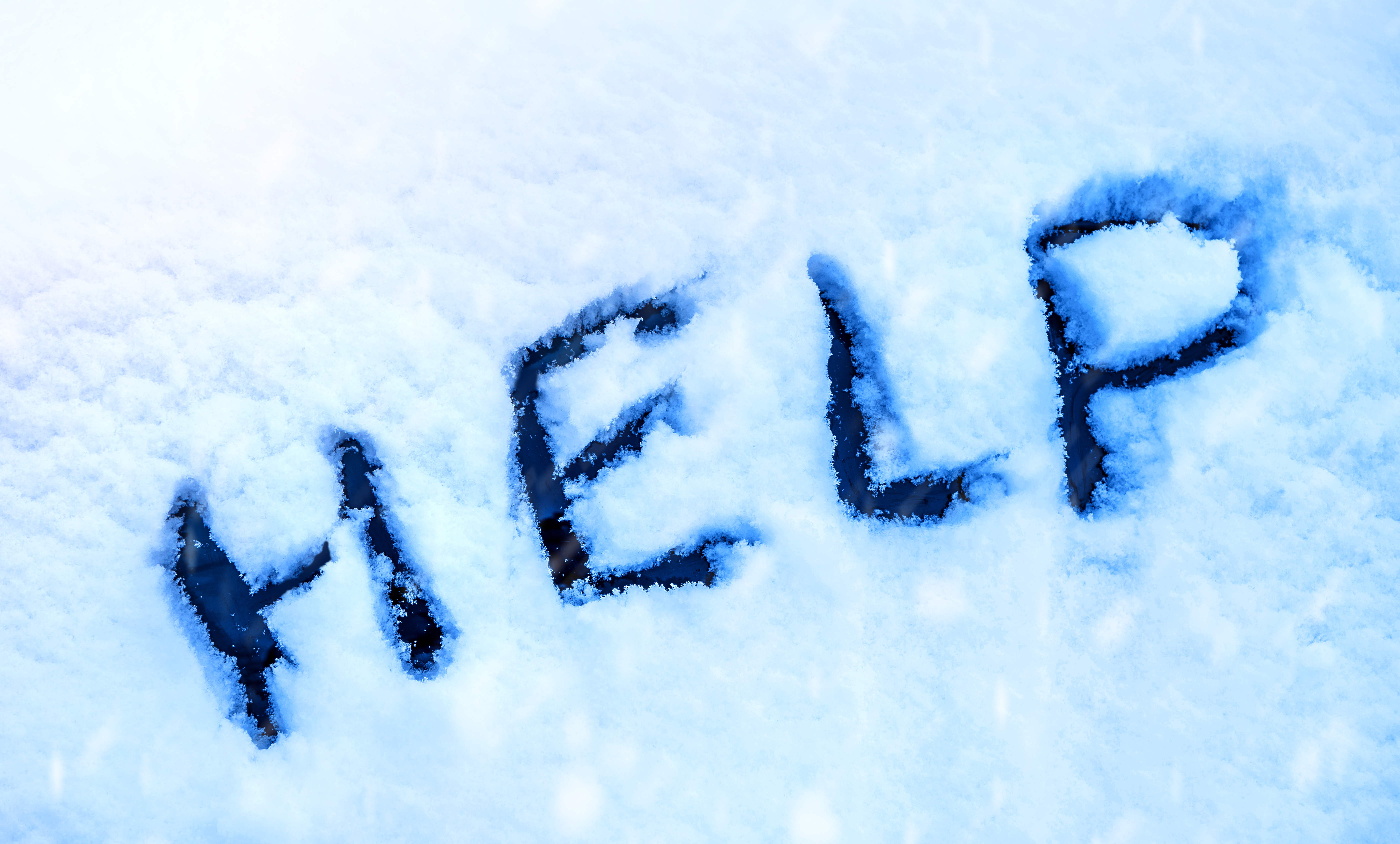 Word Help, written on a snow. | Source: Shutterstock