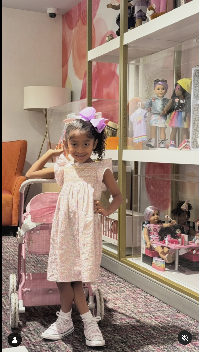 Capri Bryant smiling by a doll collection, dated May 2024 | Source: Instagram/VanessaBryant