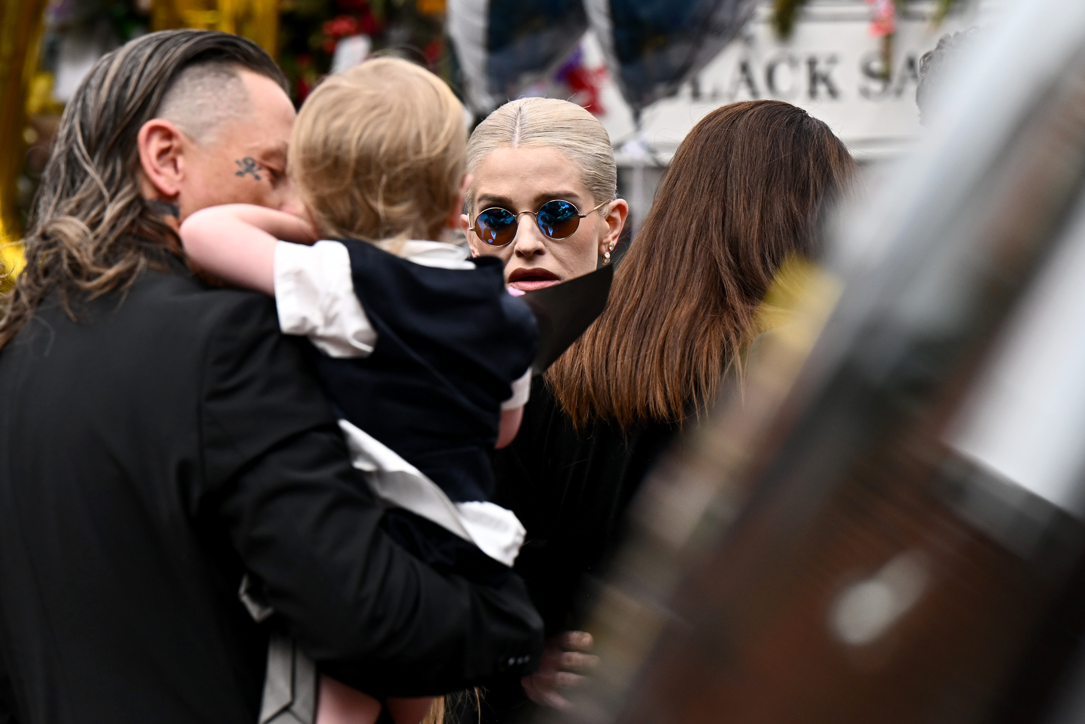 Sid Wilson, Kelly Osbourne and their son Sidney gathered to pay respects to Ozzy in Birmingham, England on July 30, 2025. | Source: Getty Images