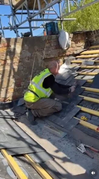 In the final clip, Hendy leans forward to secure another section of the roof, focused on precision as he works across the layered tiles. The setting — complete with brickwork, tools, and construction framework — reinforces his commitment to the craft he has returned to years after his music career. | Source: Instagram/johnhendyeast17_official