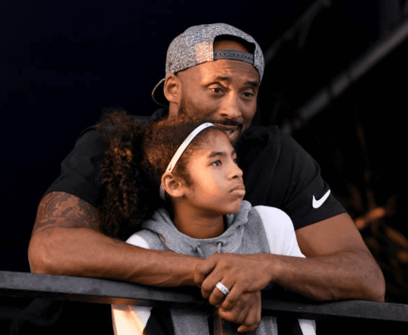Kobe Bryant and his daughter Gianna Bryant share an embrace as they watched the Phillips 66 National Swimming Championships, at the Woollett Aquatics Center, on July 26, 2018, in Irvine, California | Source: Harry How/Getty Images