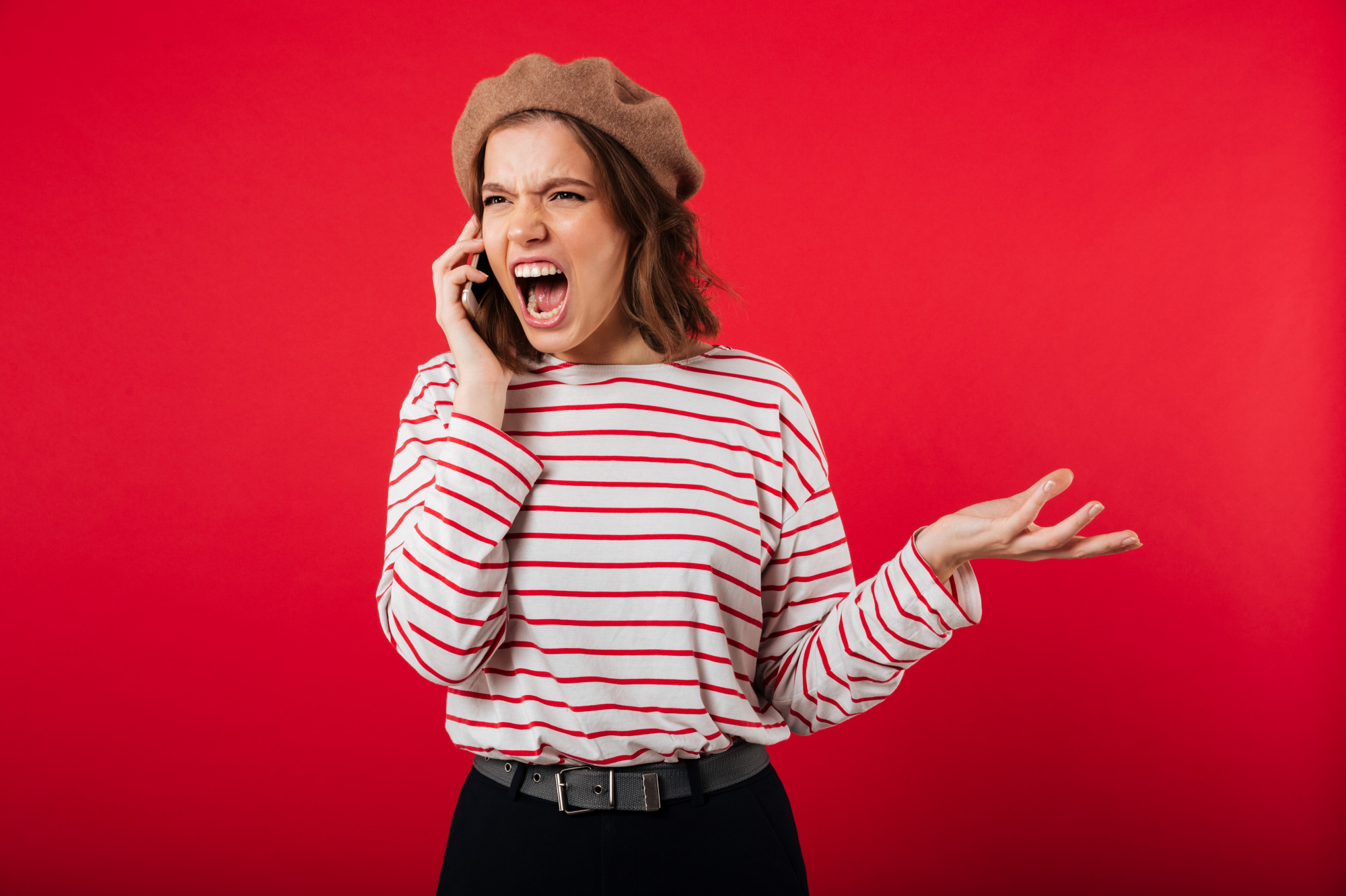 An angry woman shouting on a phone call | Source: Freepik