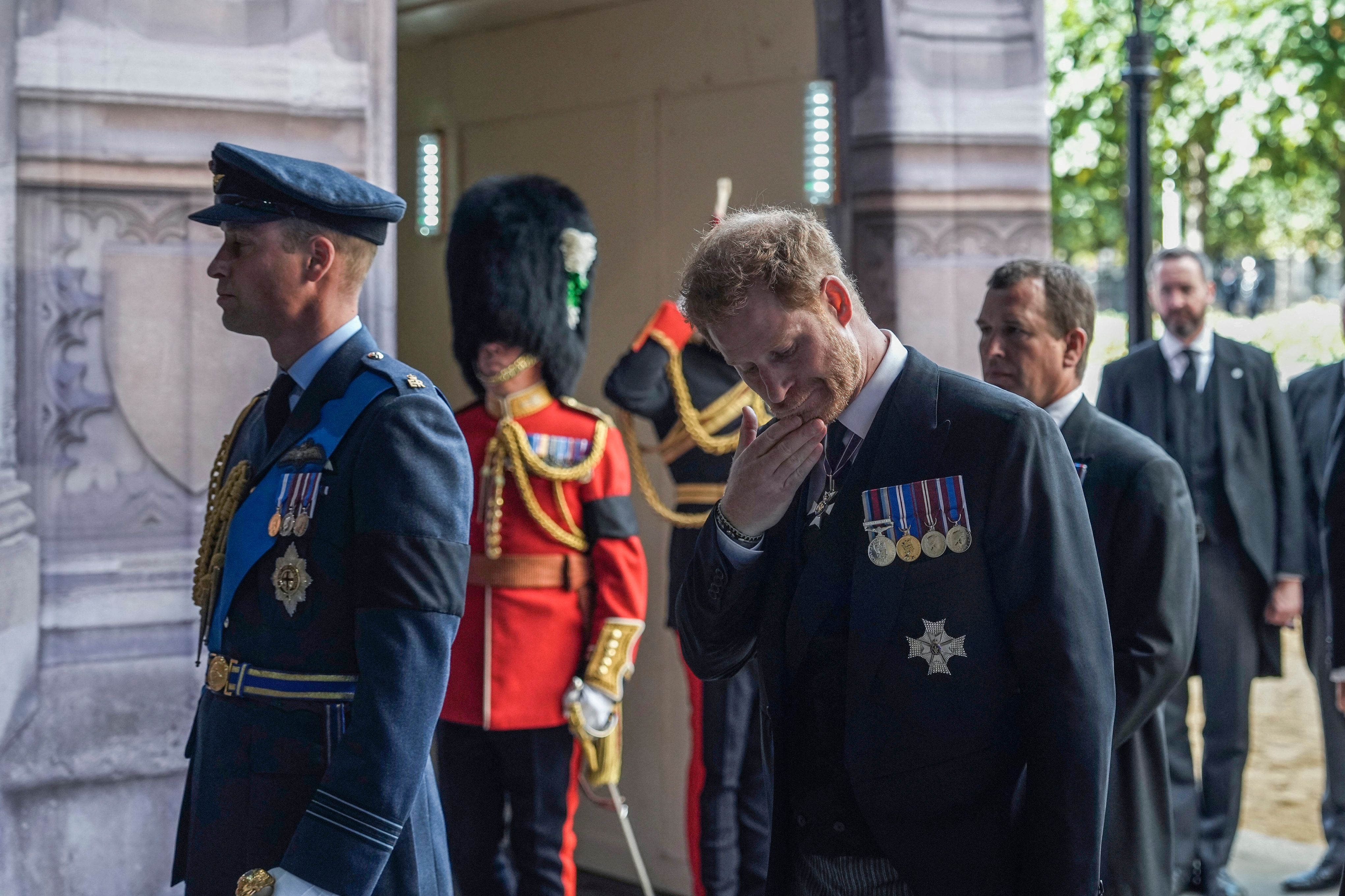 Prince William, Prince of Wales, Prince Harry, Duke of Sussex and Peter Phillips walk behind the coffin of Queen Elizabeth II, adorned with a Royal Standard and the Imperial State Crown and pulled by a Gun Carriage of The King's Troop Royal Horse Artillery, during a procession from Buckingham Palace to the Palace of Westminster, in London on September 14, 2022 | Source: Getty Images 