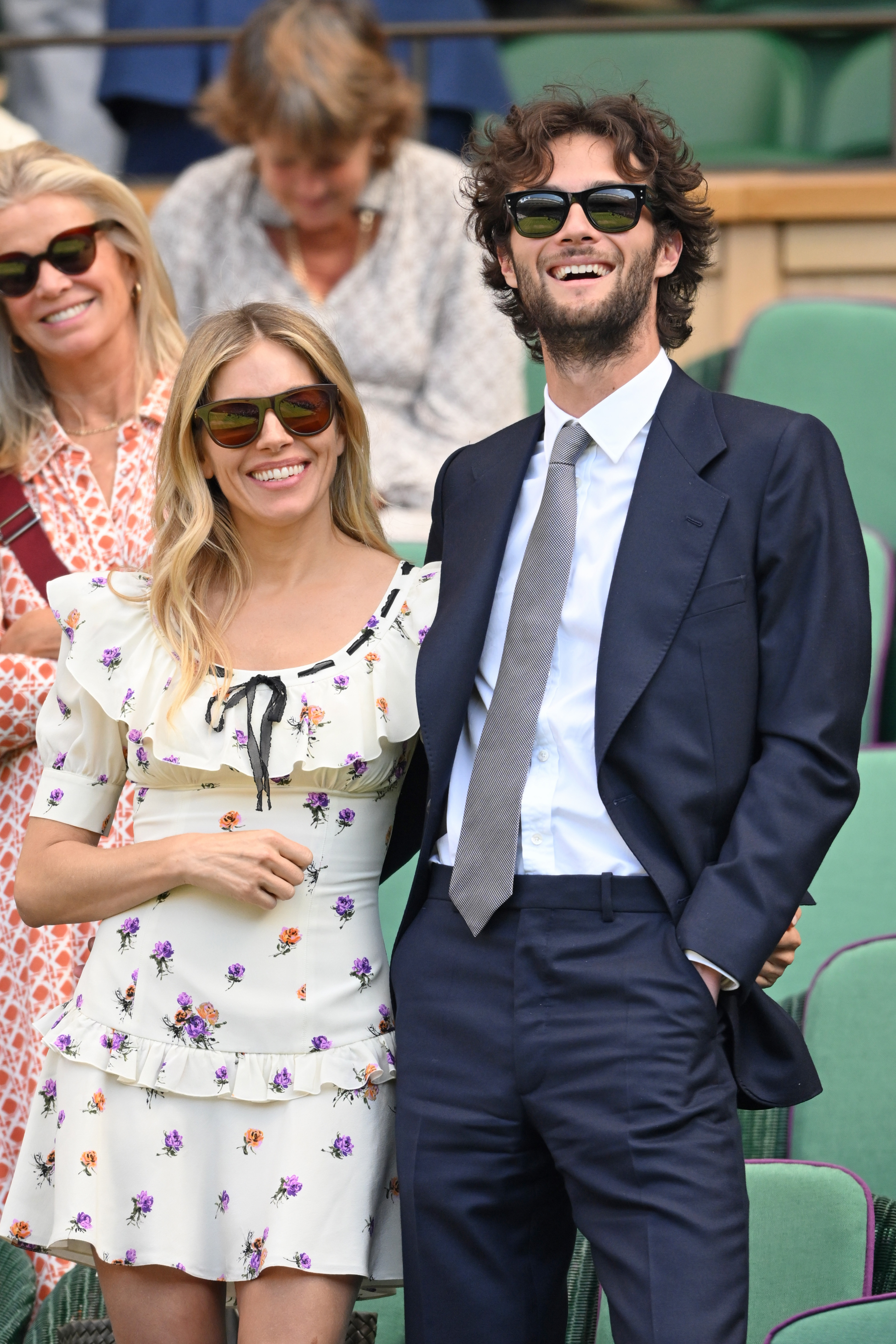 Sienna Miller and Oli Green react to the action court-side on day nine of the Wimbledon Tennis Championships at the All England Lawn Tennis and Croquet Club on 8 July 2025 in London, England. | Source: Getty Images