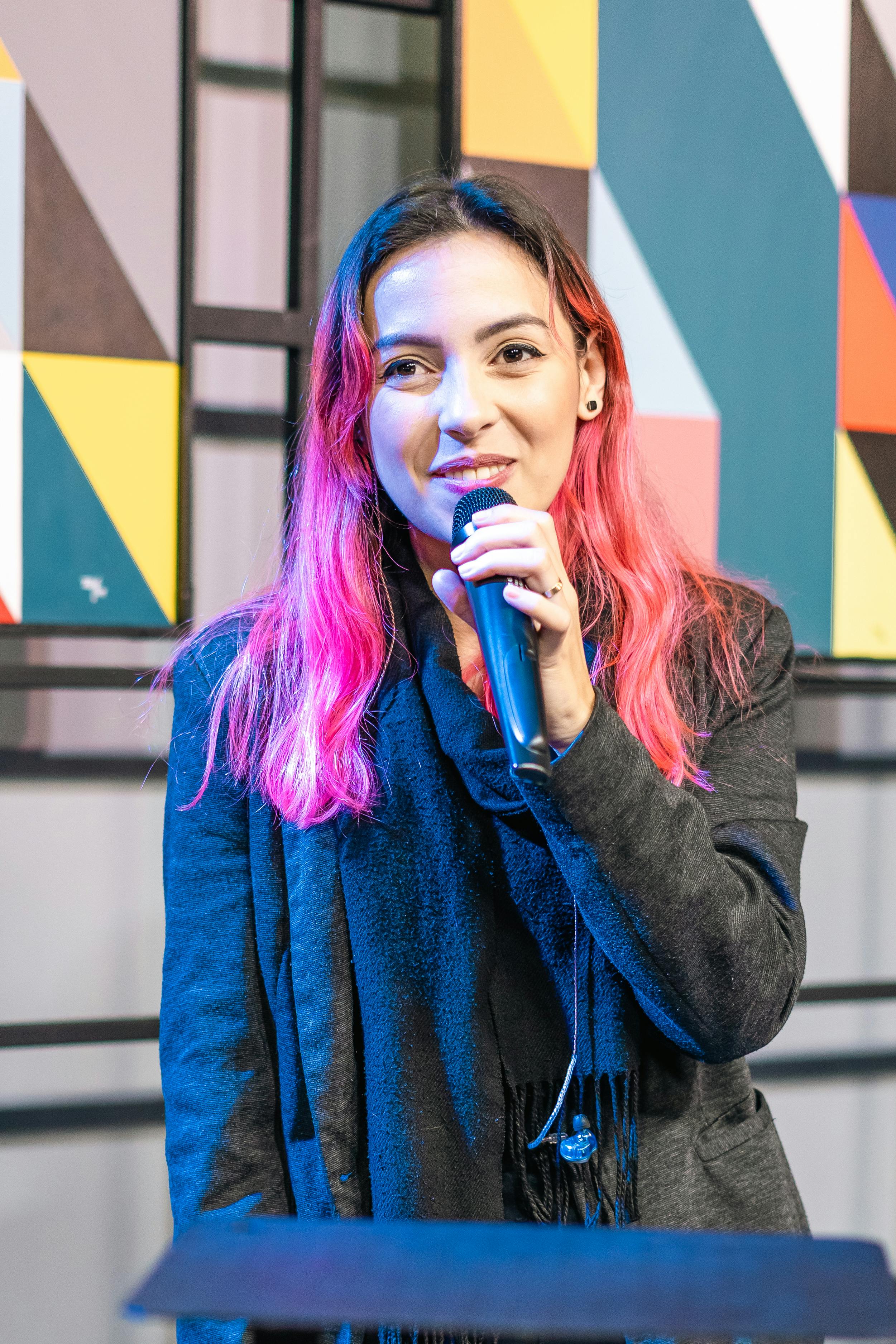 A woman holding a microphone | Source: Pexels