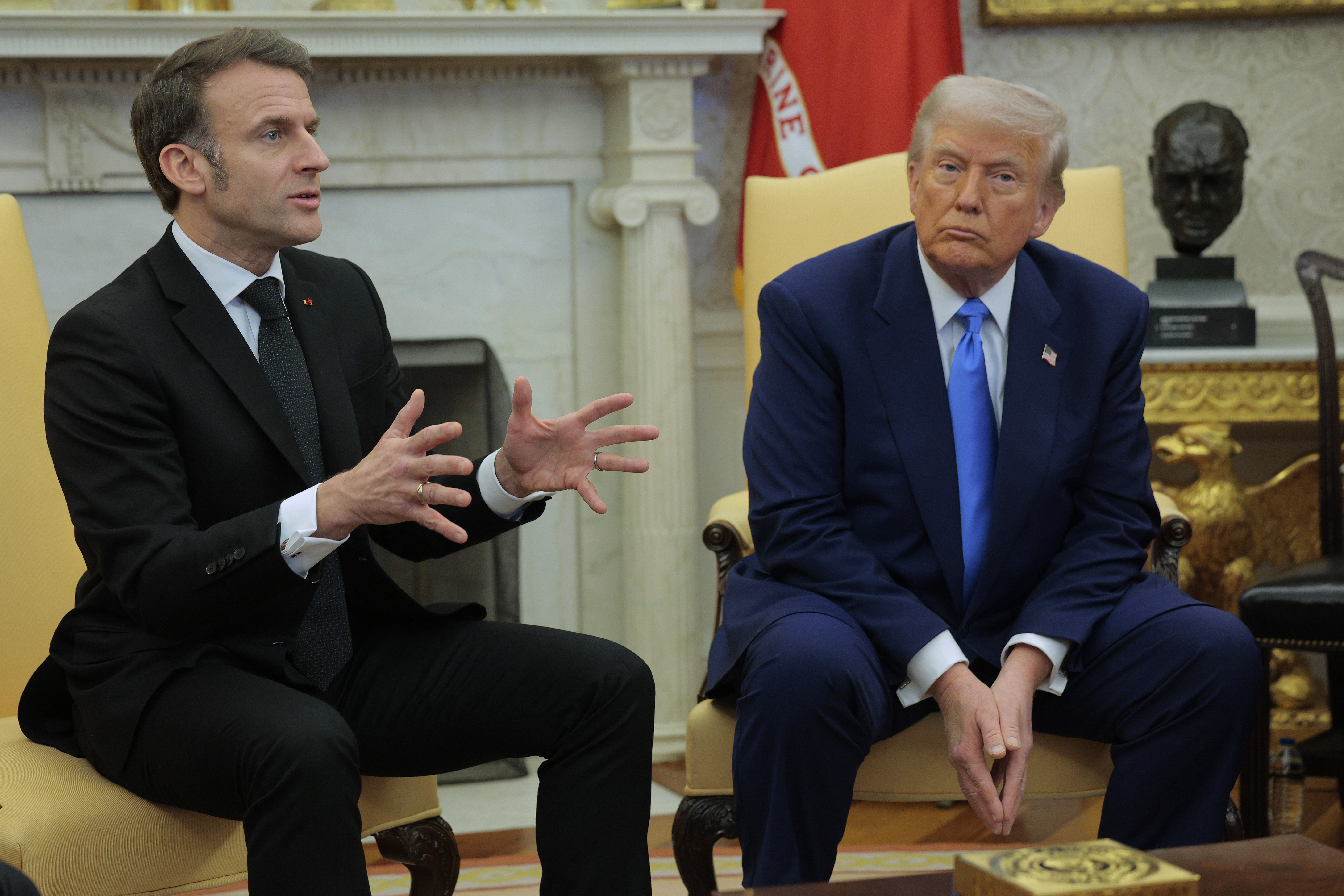 Donald Trump listens as Emmanuel Macron answers a reporter's question in the Oval Office at the White House in Washington, DC, on February 24, 2025 | Source: Getty Images