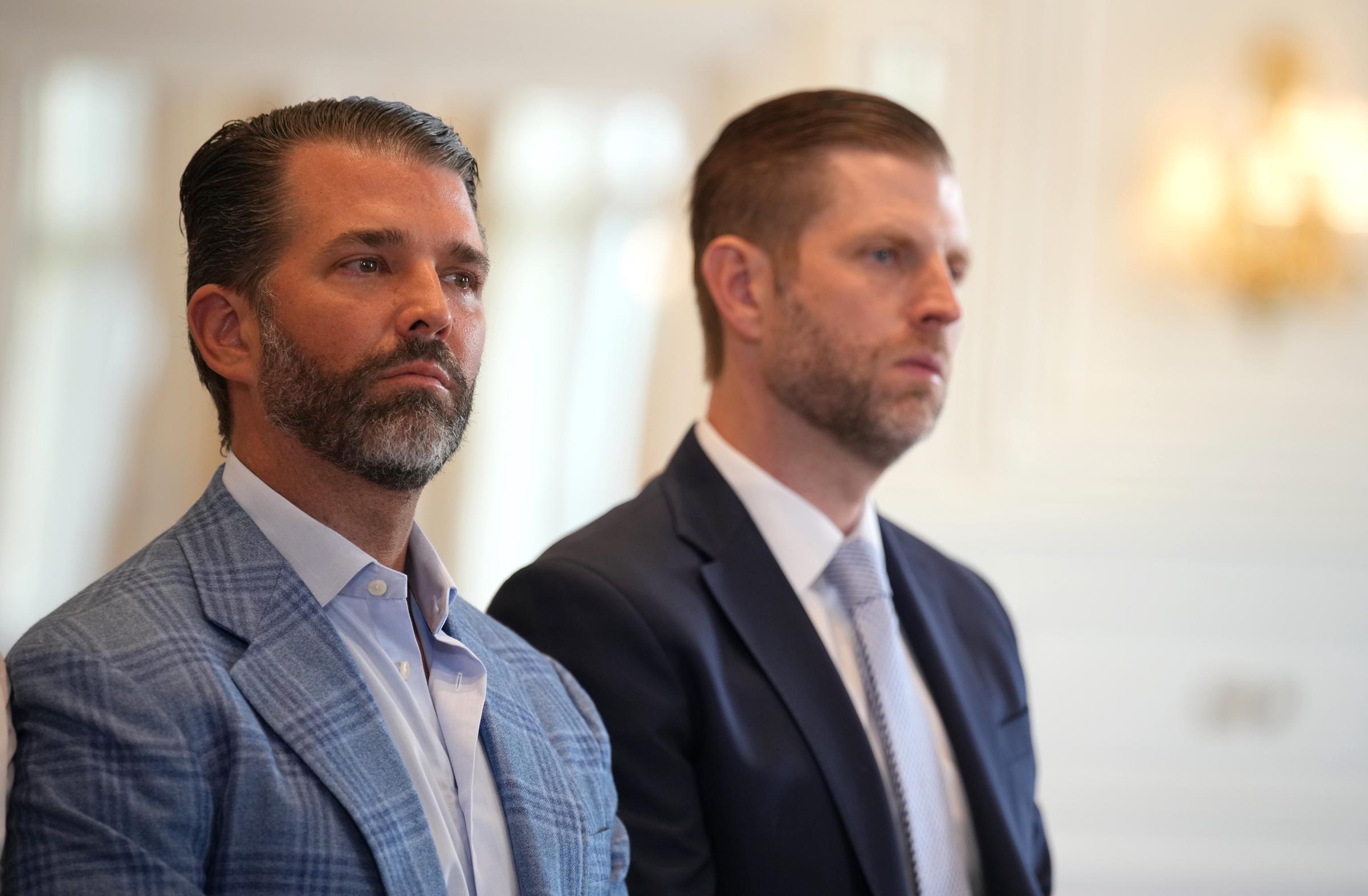 Donald Trump Jr. and Eric Trump look on as President Donald Trump and President of the European Commission Ursula von der Leyen announce a US-EU trade deal after a meeting at Trump Turnberry golf club on July 27, 2025, in Turnberry, Scotland | Source: Getty Images