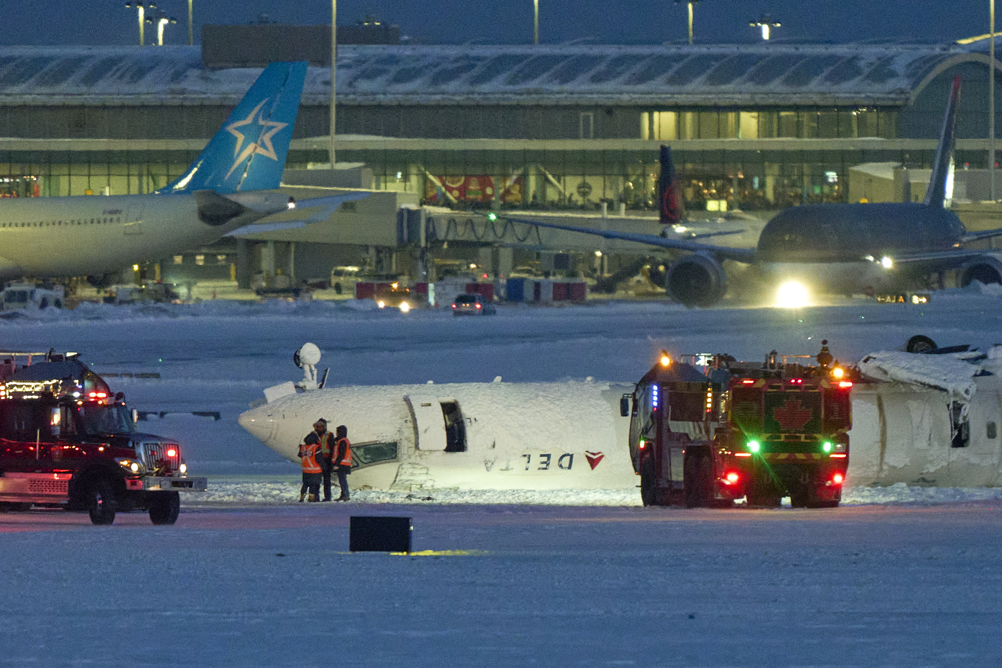 A Delta airlines plane sits on its roof after crashing upon landing at Toronto Pearson Airport in Toronto, Ontario, on February 17, 2025 | Source: Getty images