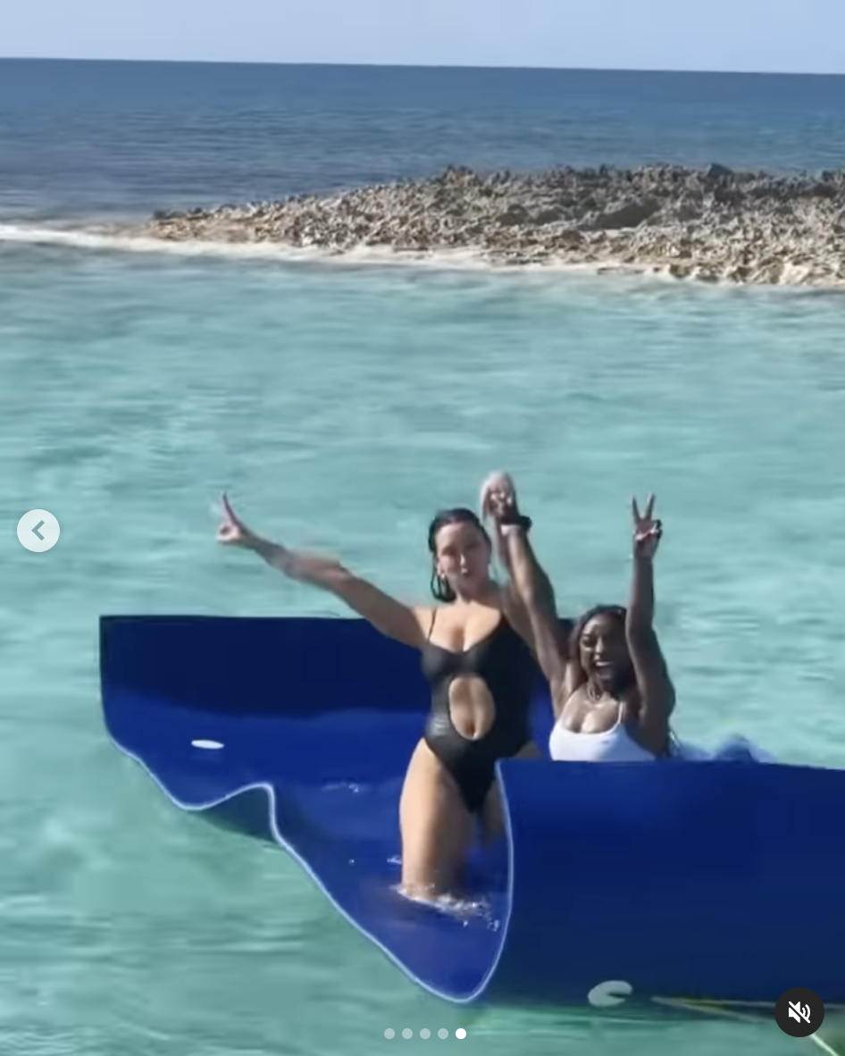 Simone Biles relaxes on a floating mat in the ocean with one of her friends during her vacation in the Bahamas, dated March 12, 2025 | Source: Instagram/simonebiles