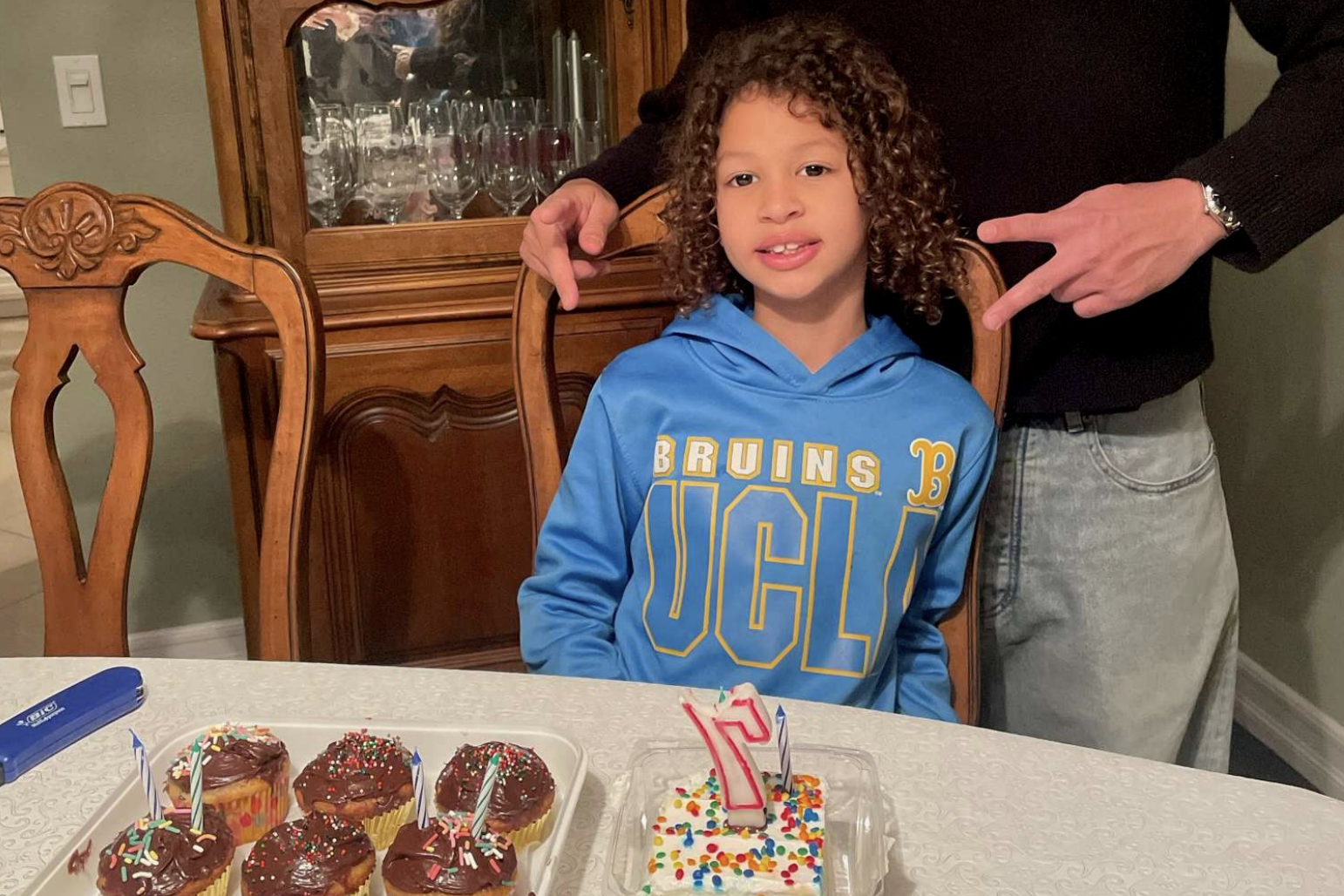 Lamar McGlothurn at home, smiling next to his birthday cupcakes | Source: State of California