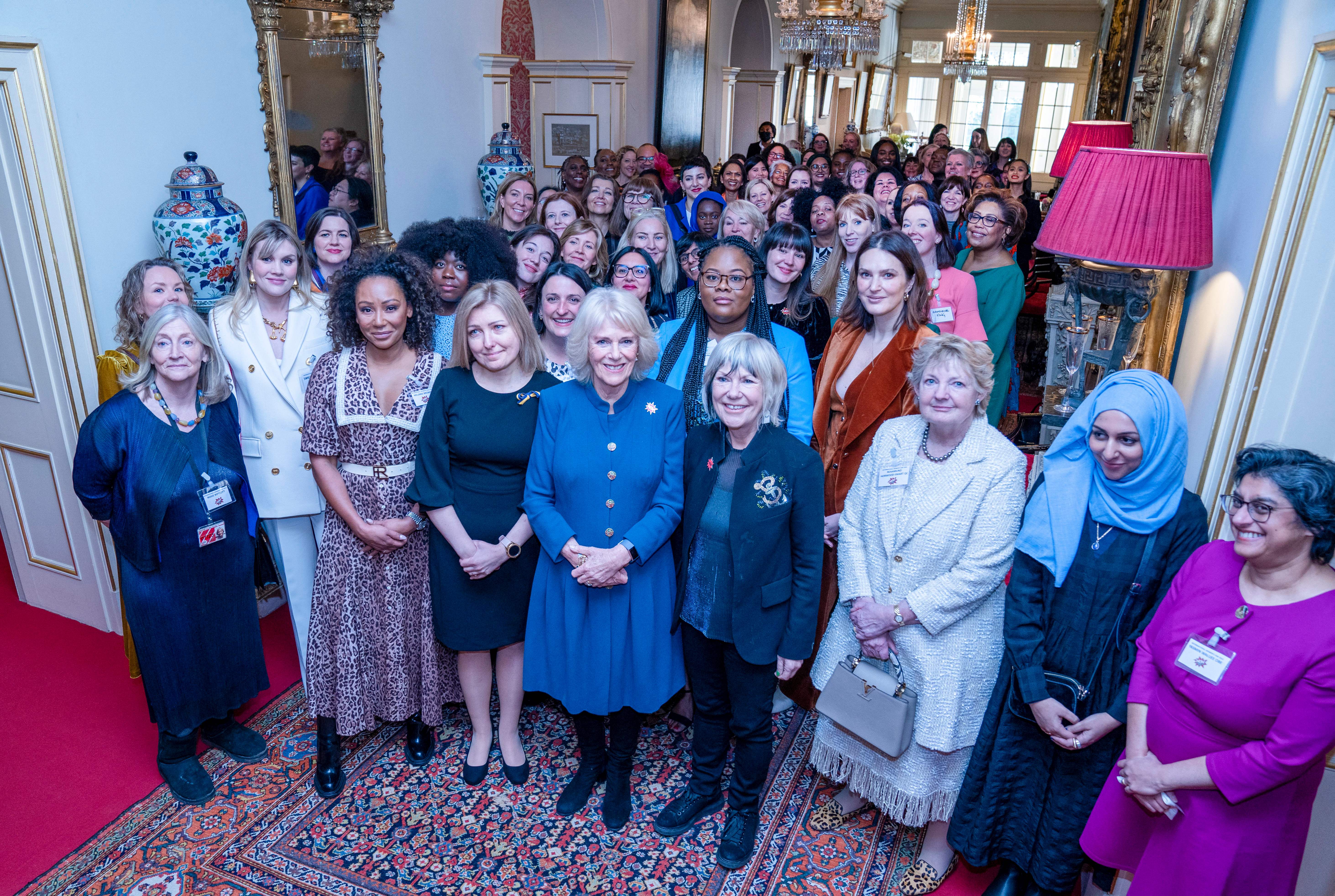 Queen Camilla poses for a group photo with attendees during a reception to mark International Women's Day at Clarence House, in London, on March 8, 2022 | Source: Getty Images