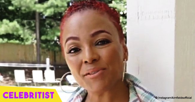 Kim Fields, 49, turns heads in black & white checked romper, showing off her red mohawk hairstyle