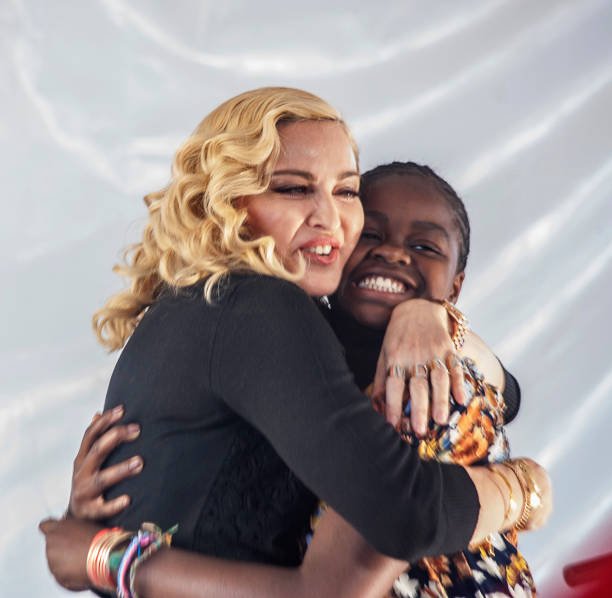 Madonna hugs her Malawian adopted daughter Mercy James after she made a speech during the opening ceremony of the Mercy James Children's Hospital at Queen Elizabeth Central Hospital in Blantyre, Malawi, on July 11, 2017 | Photo: Getty Images
