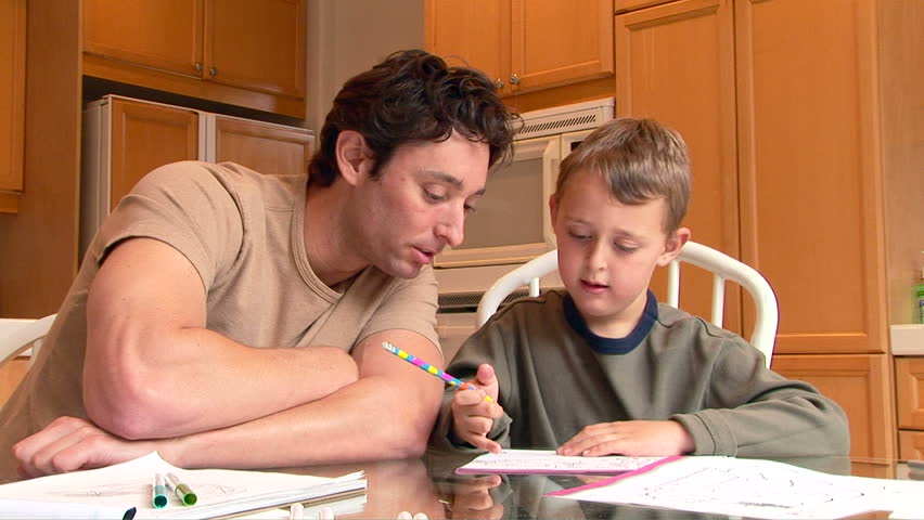 Father helping son with homework | Photo: Shutterstock.com
