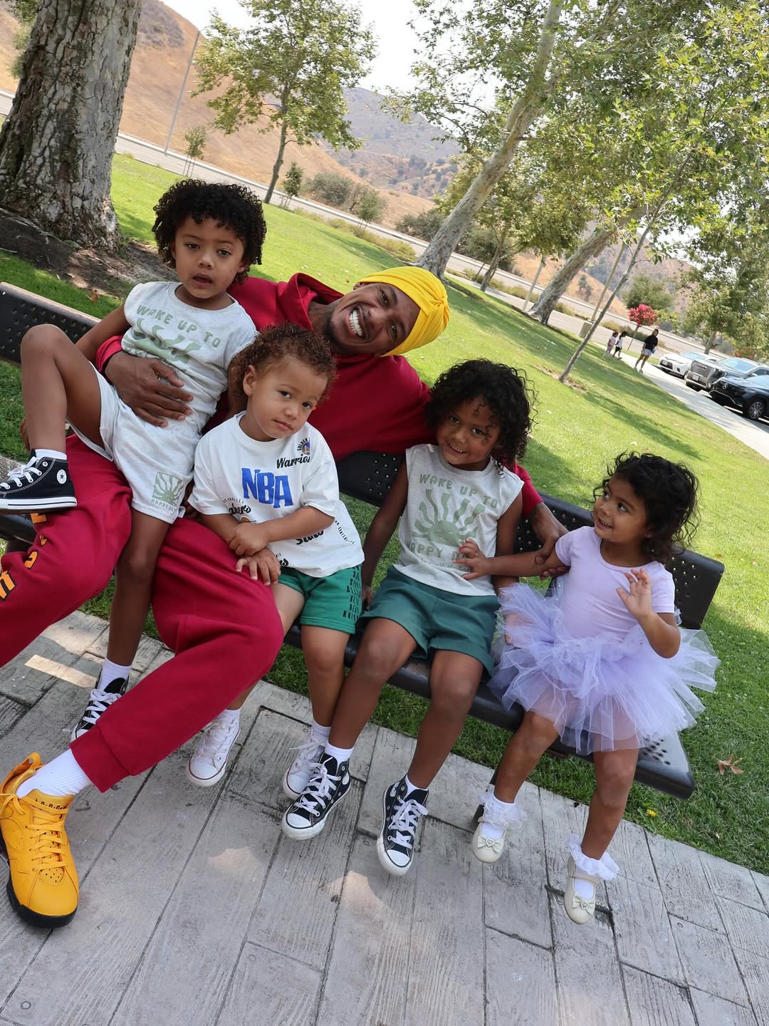Nick Cannon sits with four of his children while he carries one of them on his lap from a post dated August 6, 2025. | Source: Instagram/nickcannon