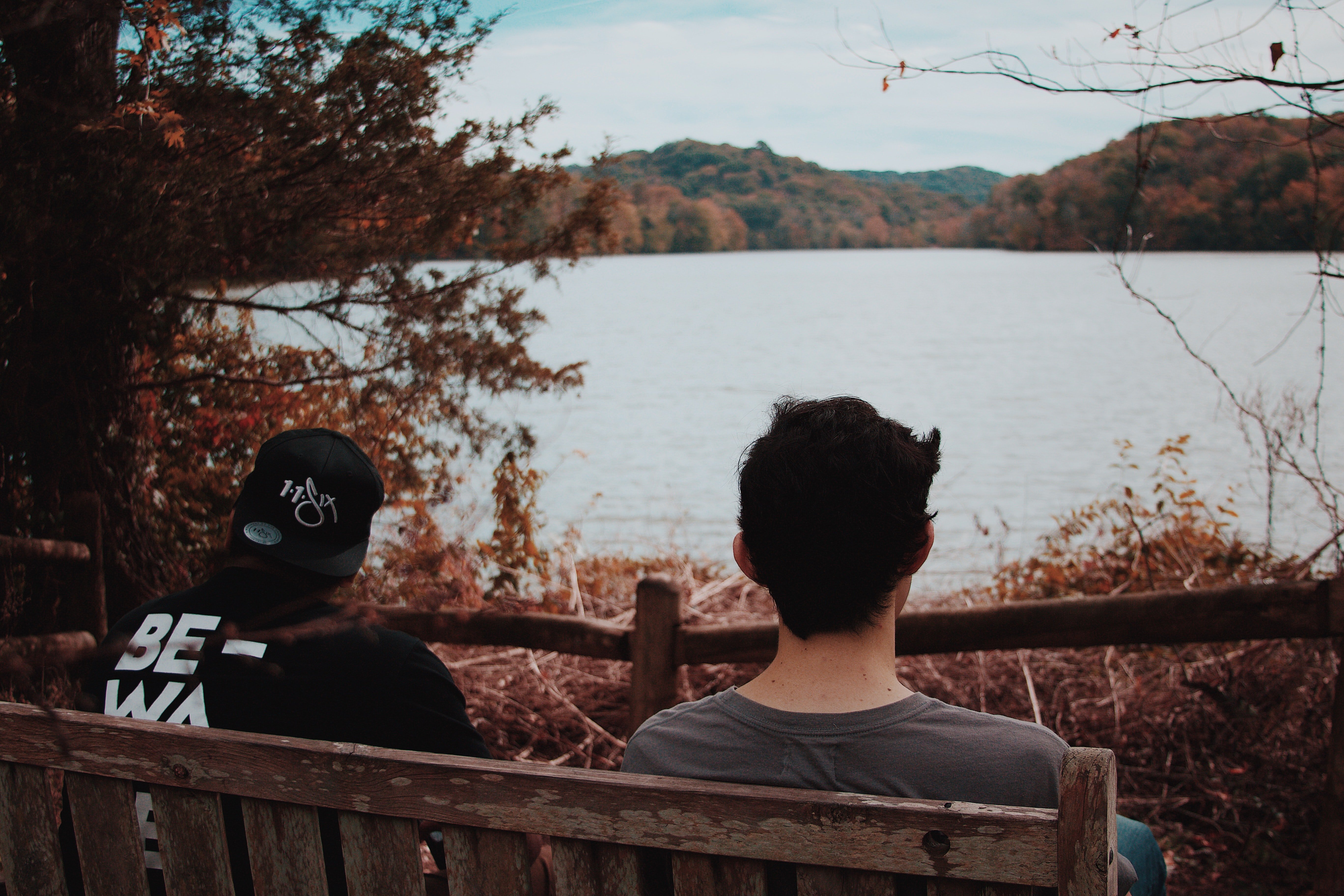 Two men watch a beautiful landscape while recalling their past | Photo: Unsplash